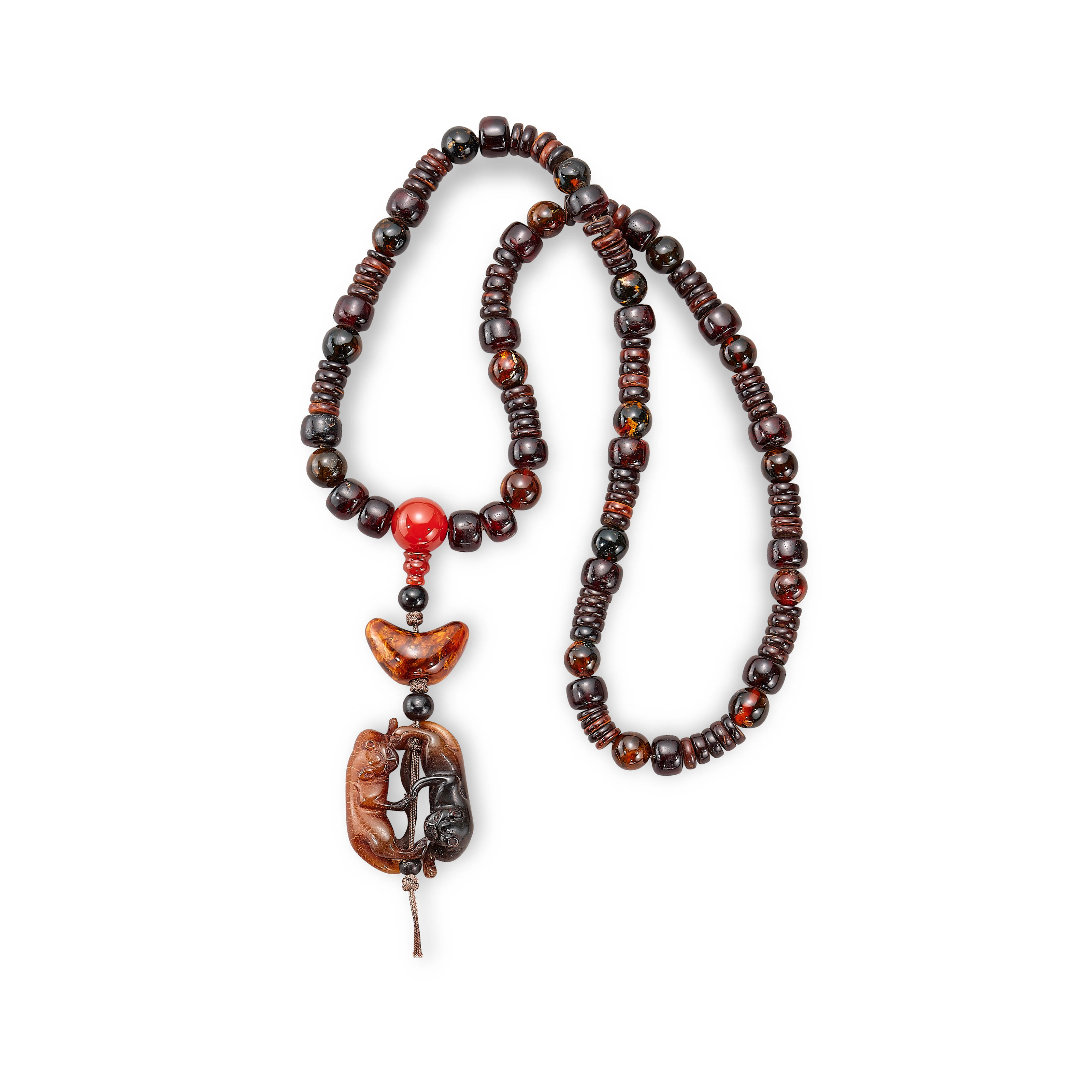 A BEADED AMBER NECKLACE WITH A COWHORN CARVING OF TWIN BADGERS