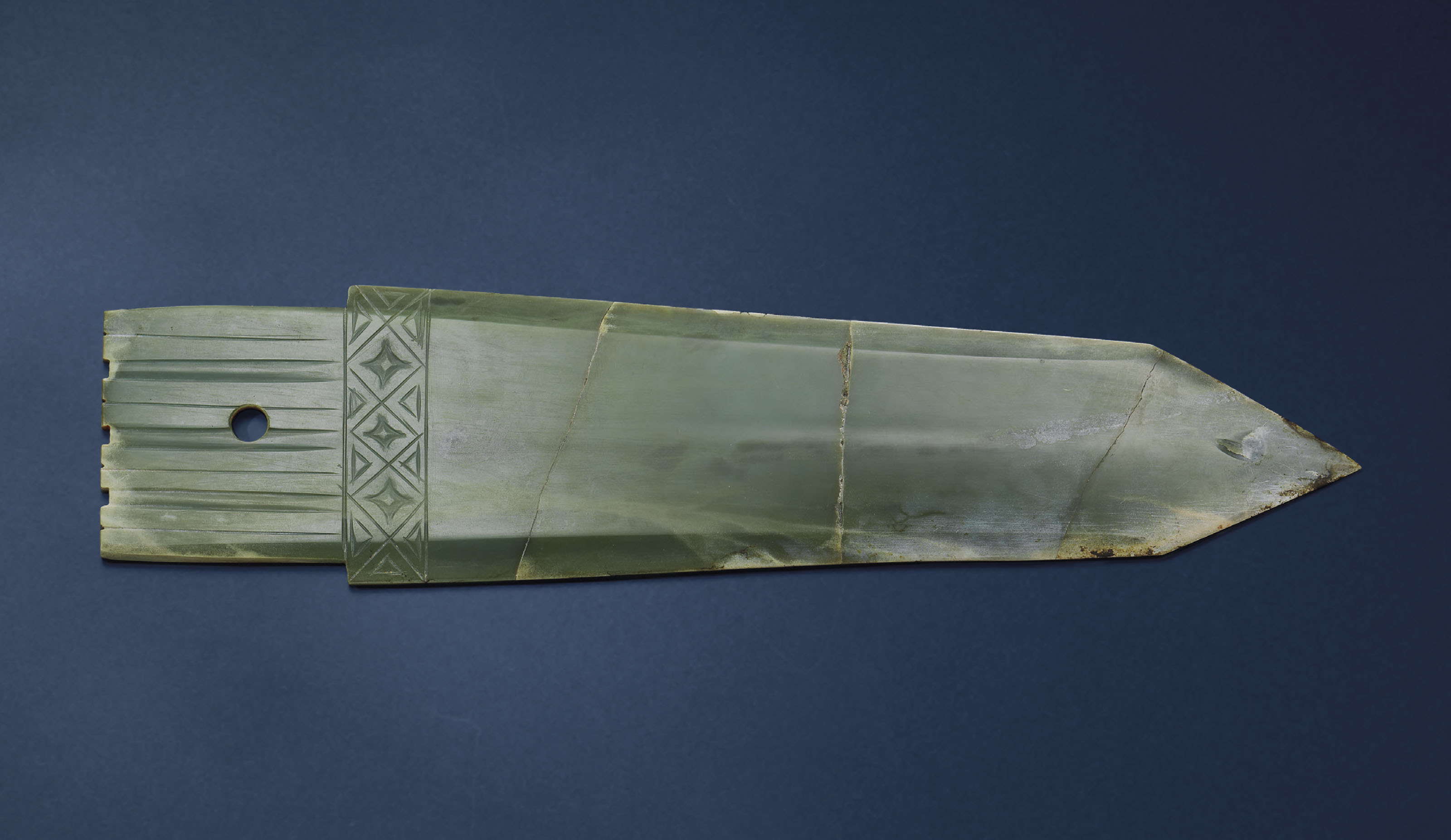 A LARGE GREEN AND RUSSET JADE GE HALBERD  BLADE