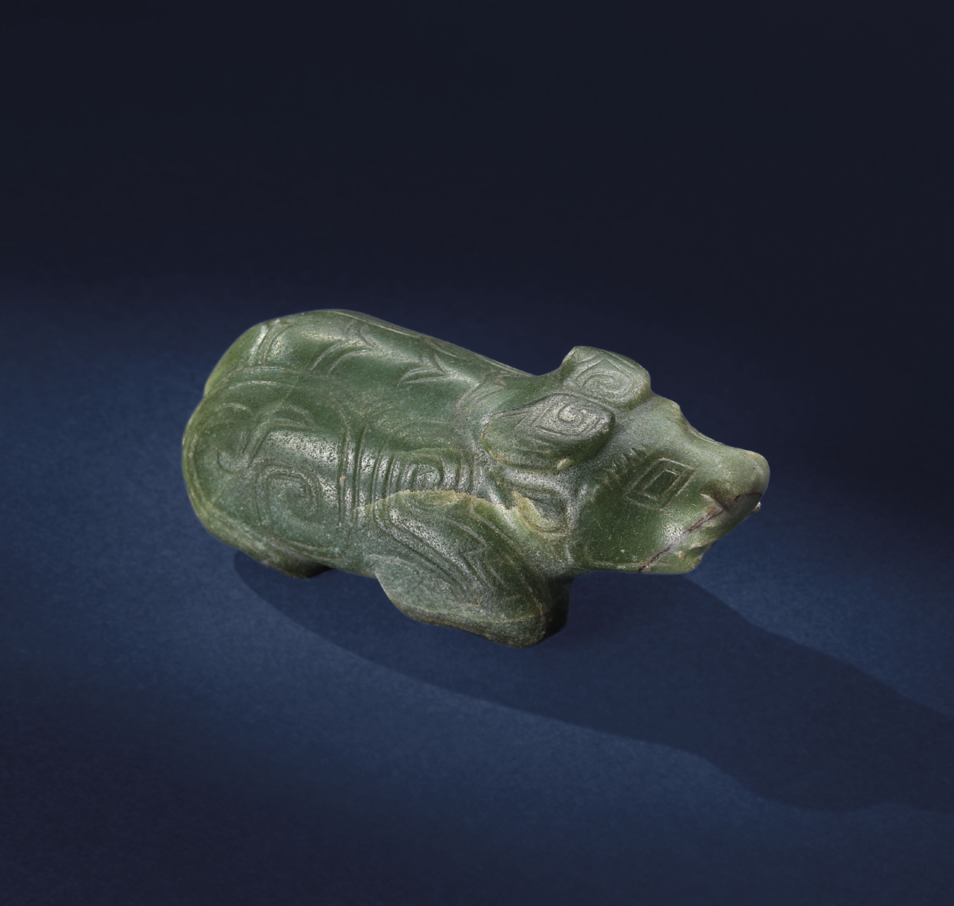 A CELADON JADE CARVING OF A BUFFALO , SHANG DYNASTY, C. 16001046 BC