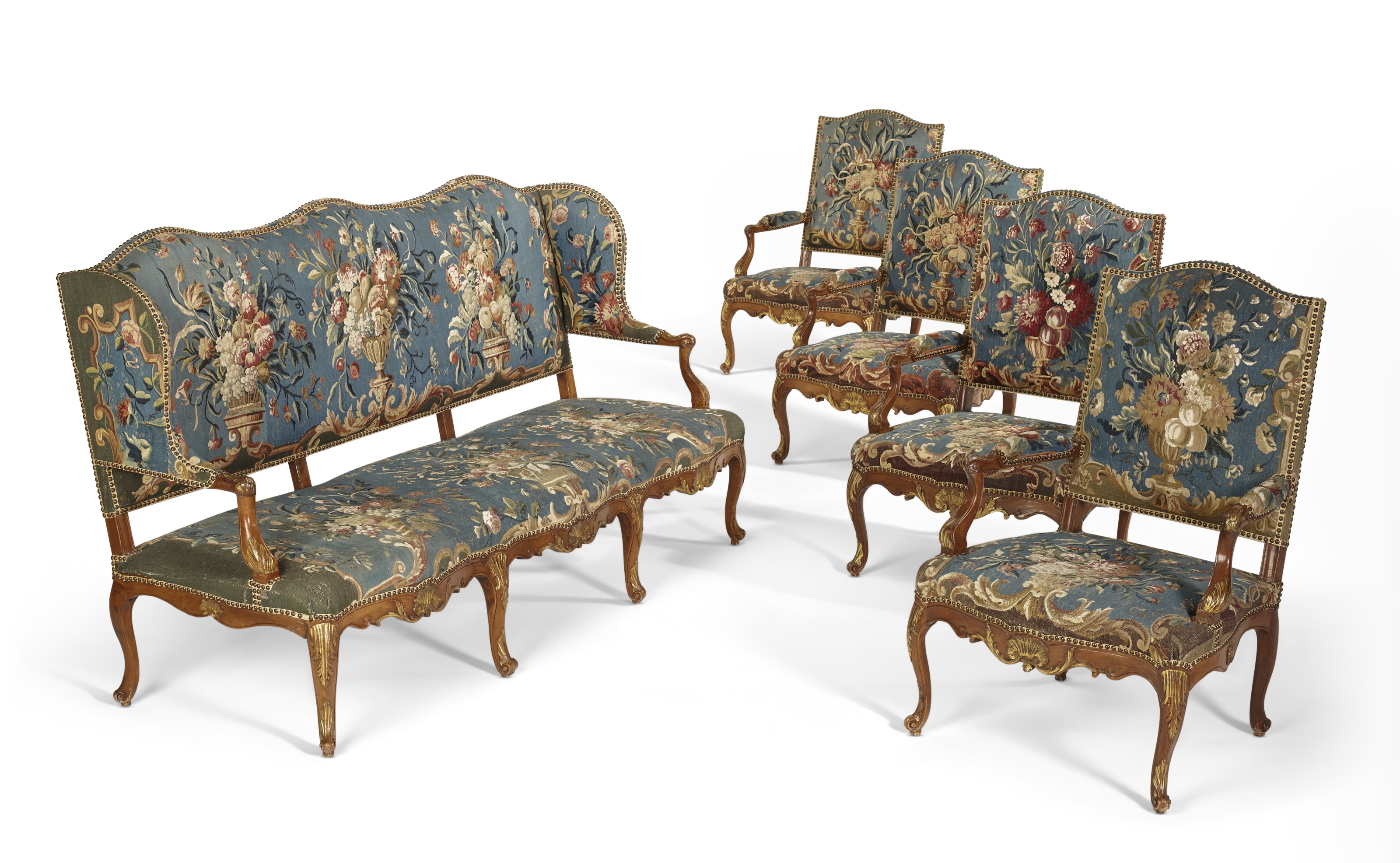 A SUITE OF EARLY LOUIS XV PARCEL-GILT WALNUT SEAT FURNITURE, CIRCA