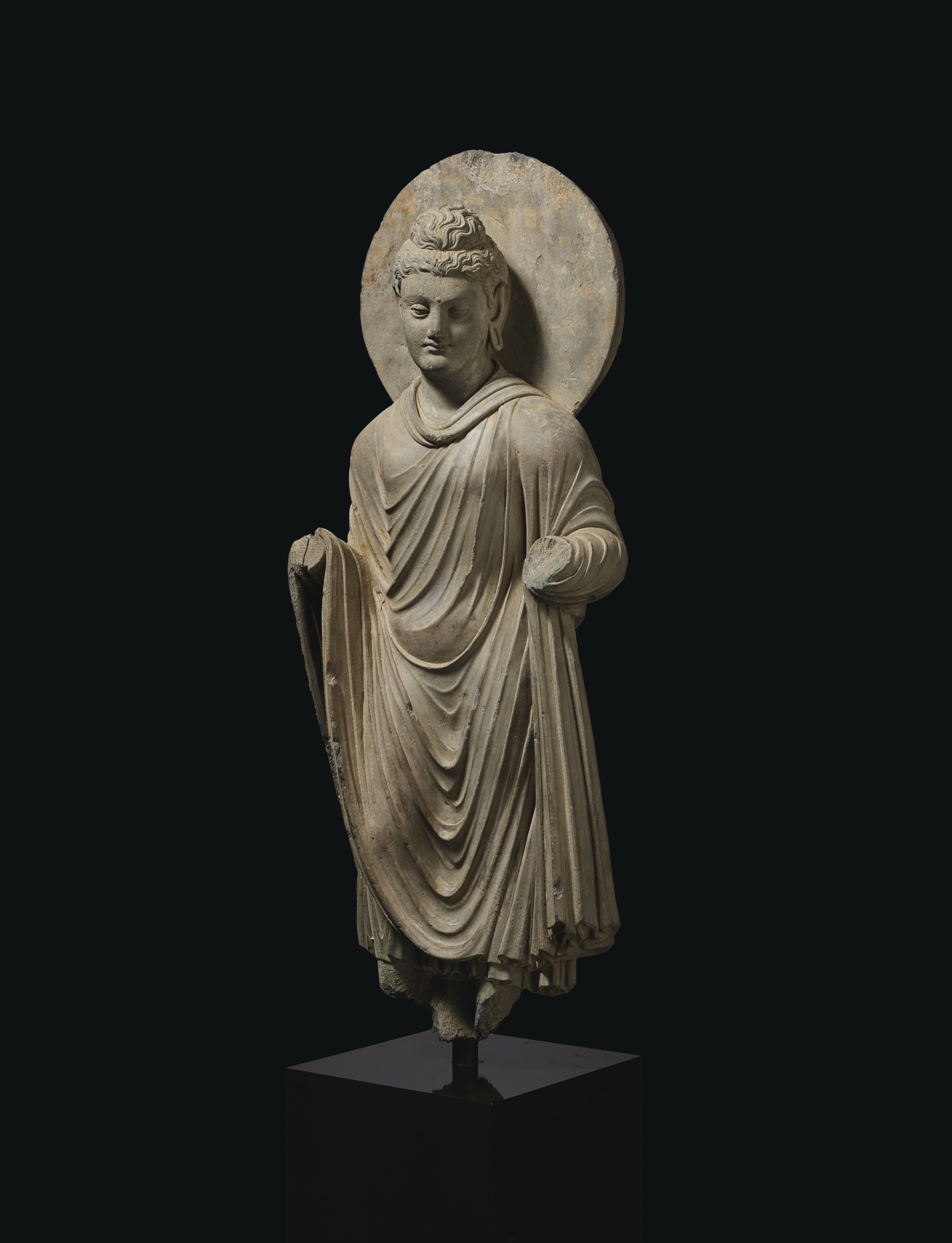 A GRAY SCHIST FIGURE OF BUDDHA SHAKYAMUNI, ANCIENT REGION OF