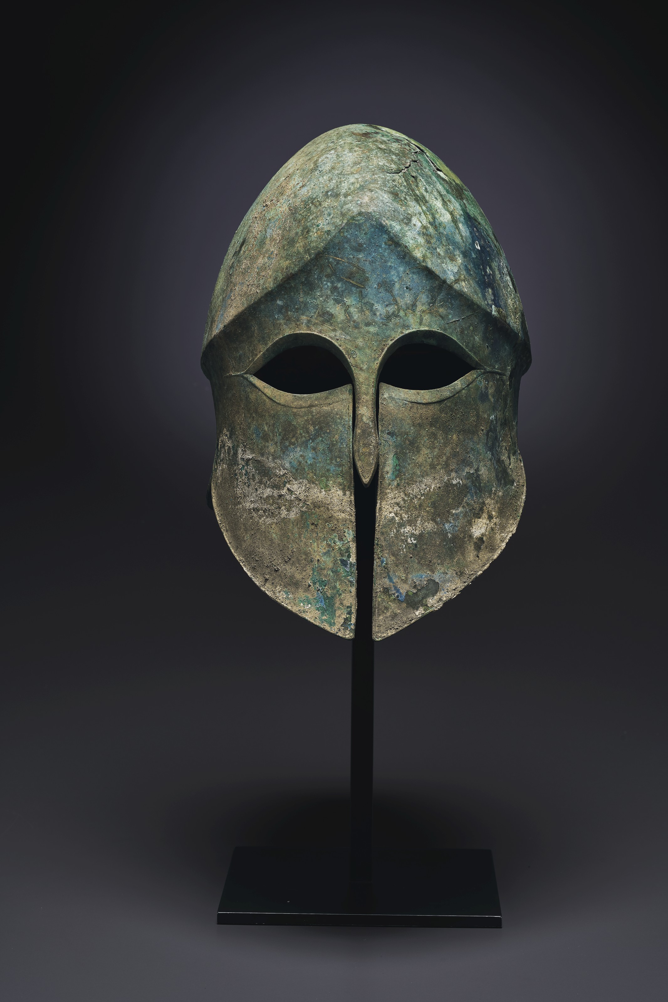 A GREEK BRONZE CORINTHIAN HELMET, ARCHAIC PERIOD, CIRCA 525475 B.C