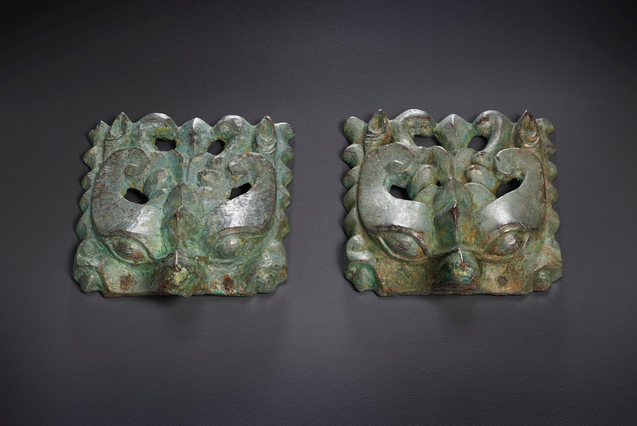 A PAIR OF BRONZE TAOTIE MASKS, SIX DYNASTIES PERIOD (AD 220589