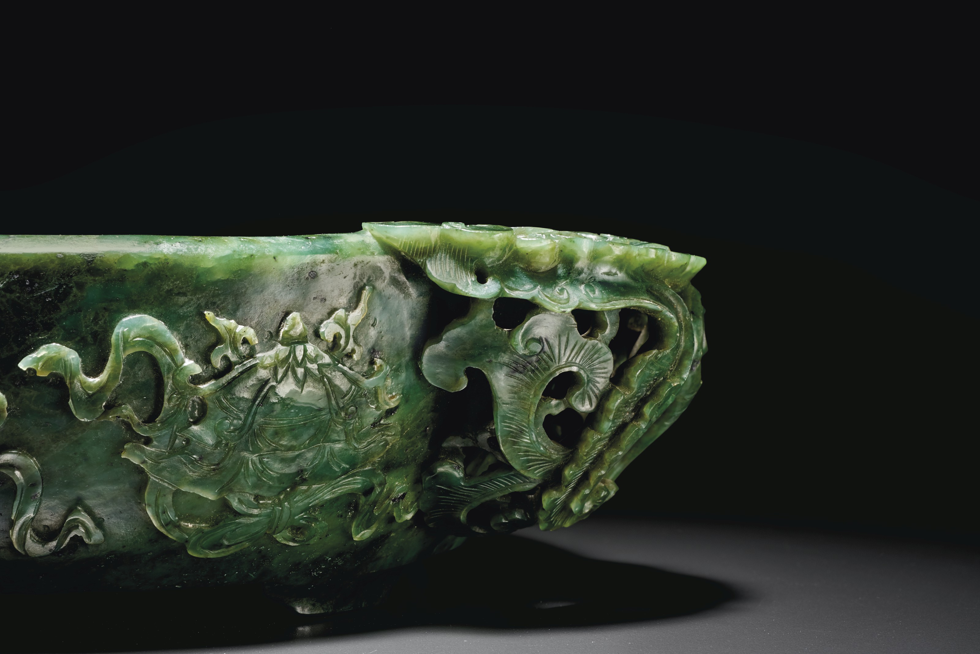 A RARE LARGE AND FINELY CARVED SPINACHGREEN JADE MARRIAGE BOWL