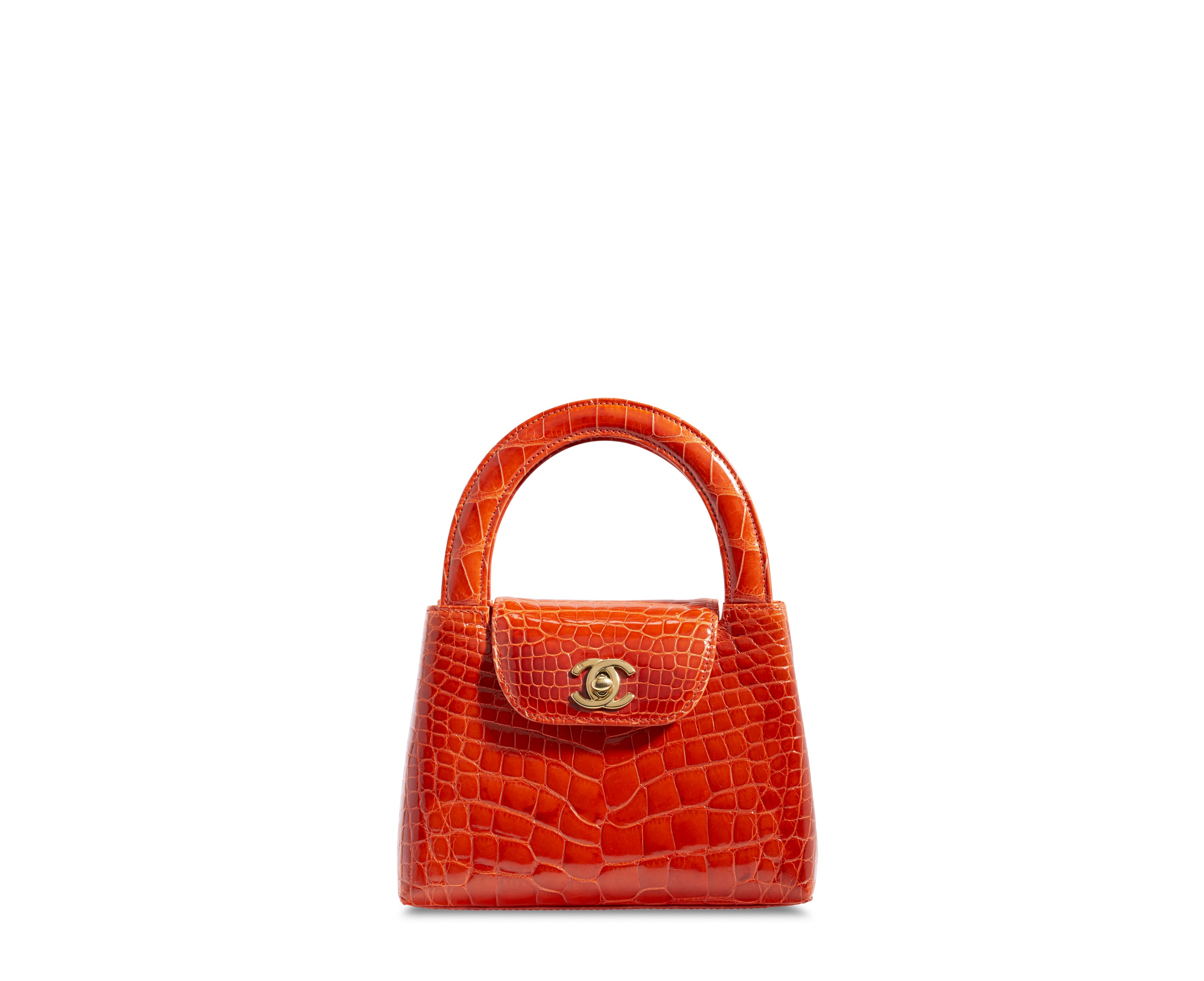 A SHINY ORANGE CROCODILE TOP HANDLE BAG WITH GOLD HARDWARE