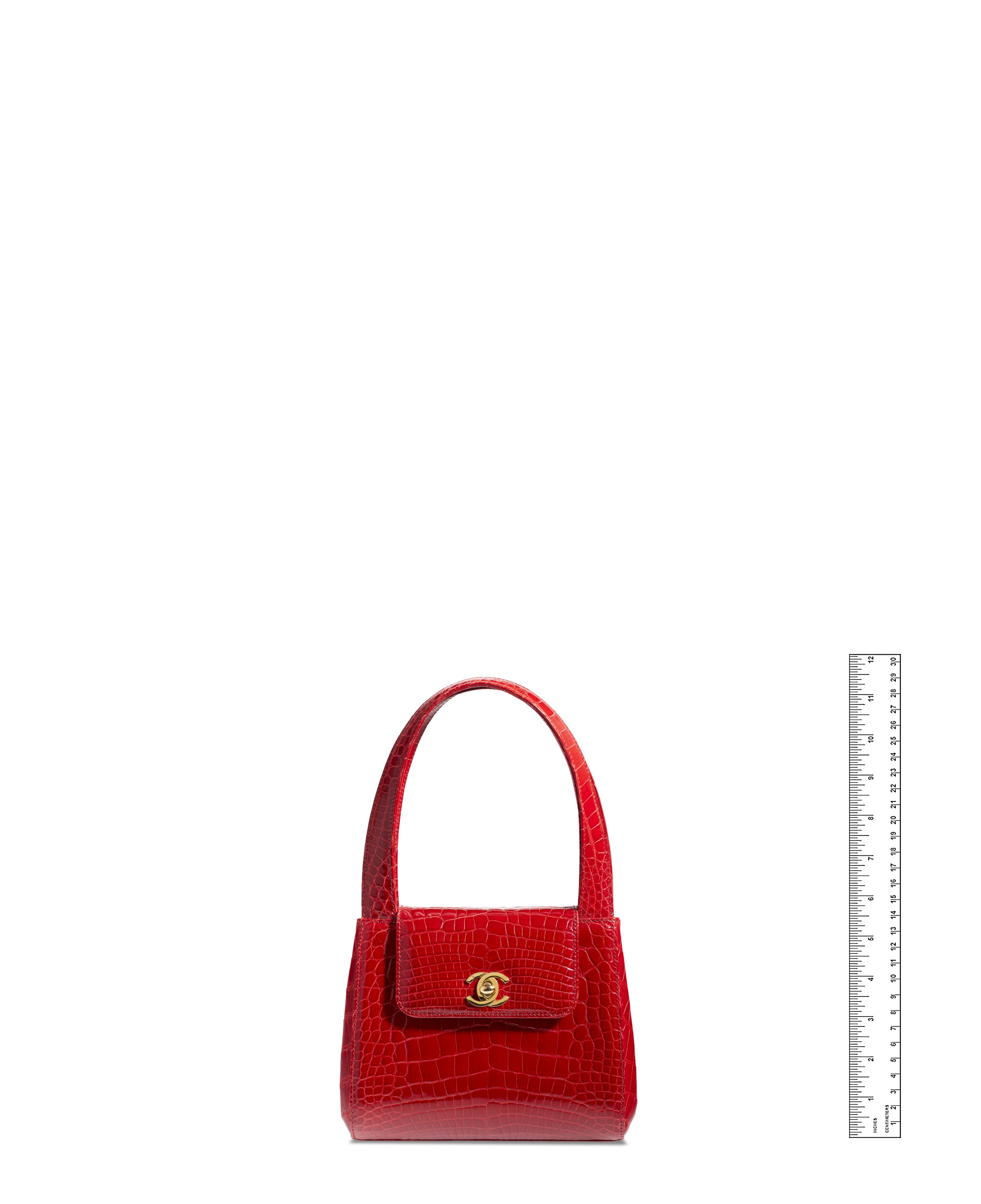 A SHINY RED CROCODILE TOP HANDLE BAG WITH GOLD HARDWARE