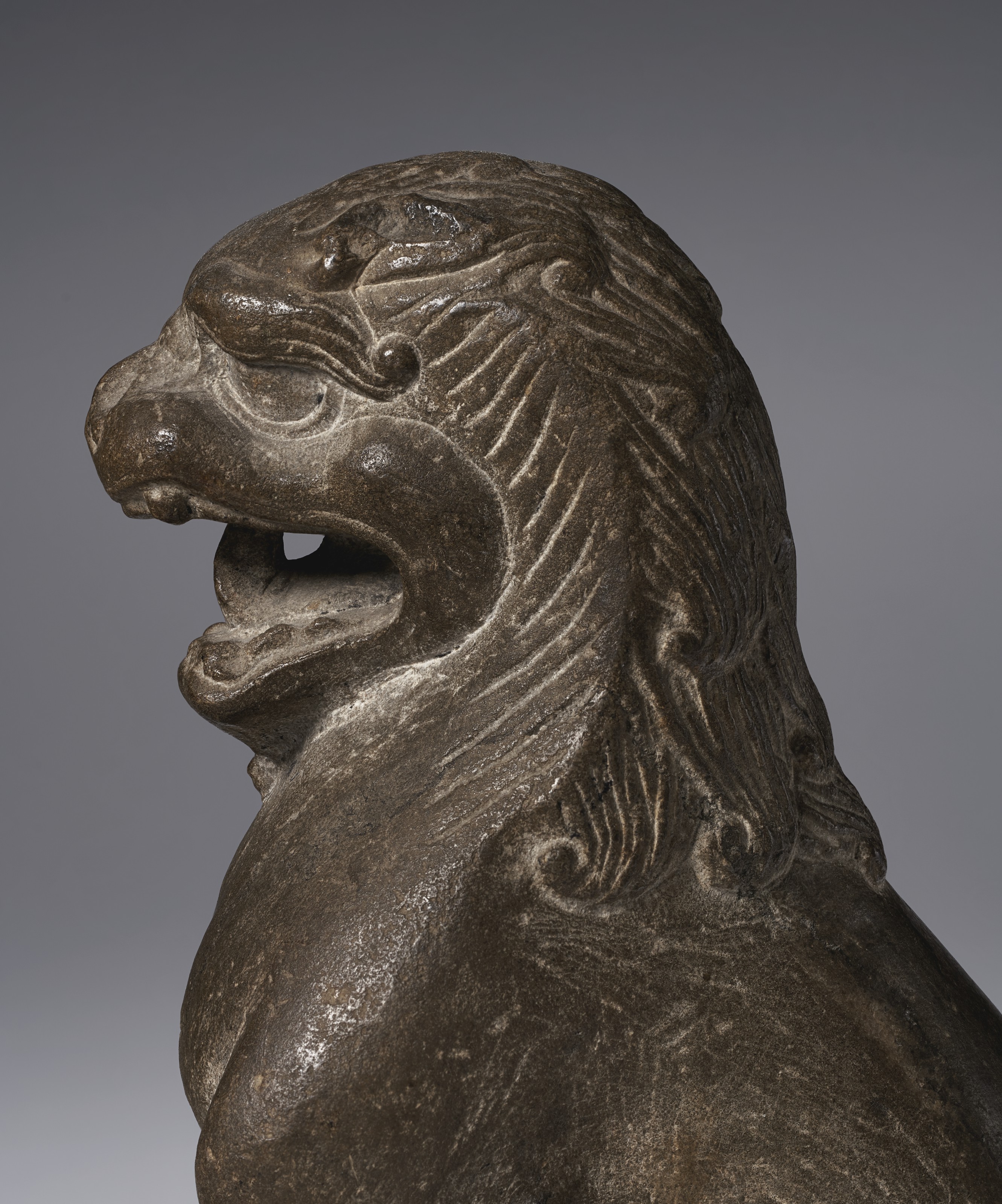 A LIMESTONE FIGURE OF A SEATED LION , CHINA, TANG DYNASTY (AD 618907