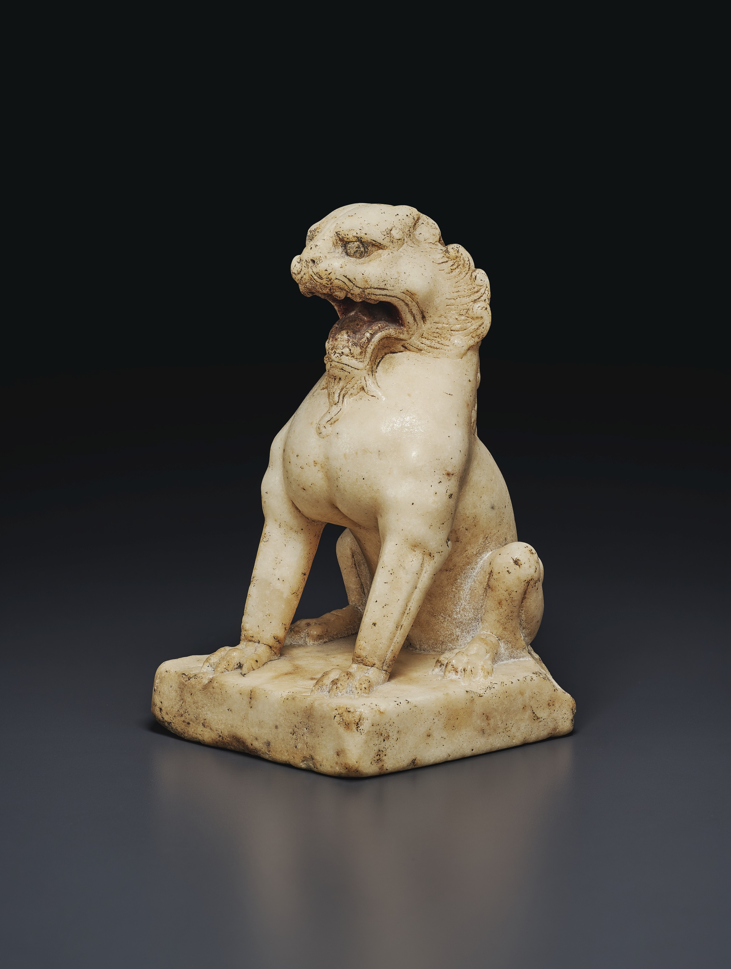 A SMALL WHITE MARBLE FIGURE OF A SEATED LION , CHINA, TANG DYNASTY (AD