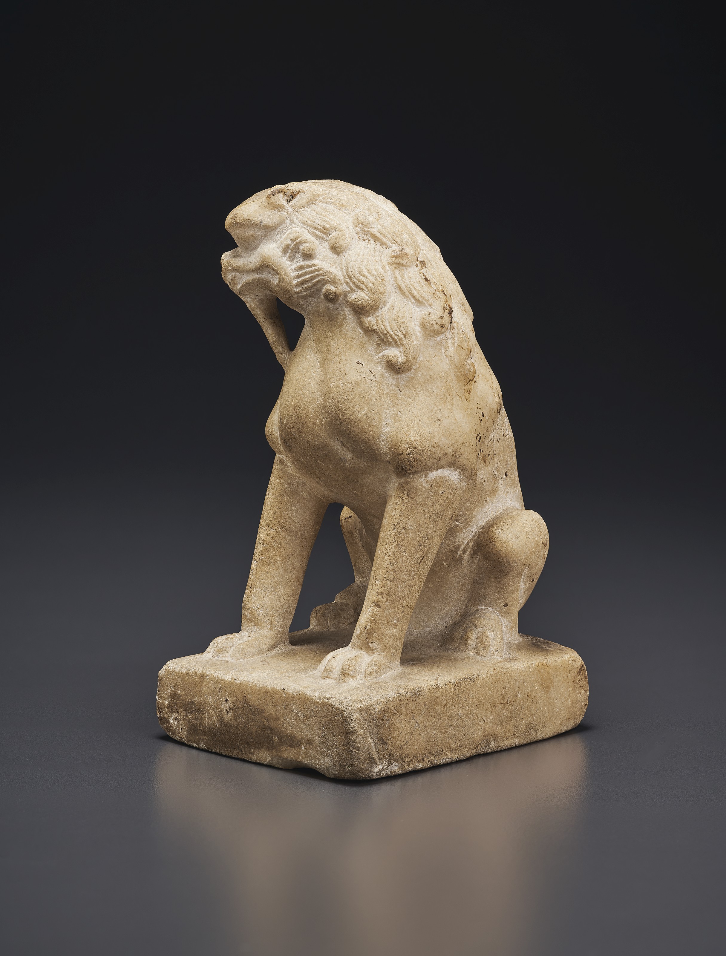 A SMALL WHITE MARBLE FIGURE OF A SEATED LION , CHINA, TANG DYNASTY (AD