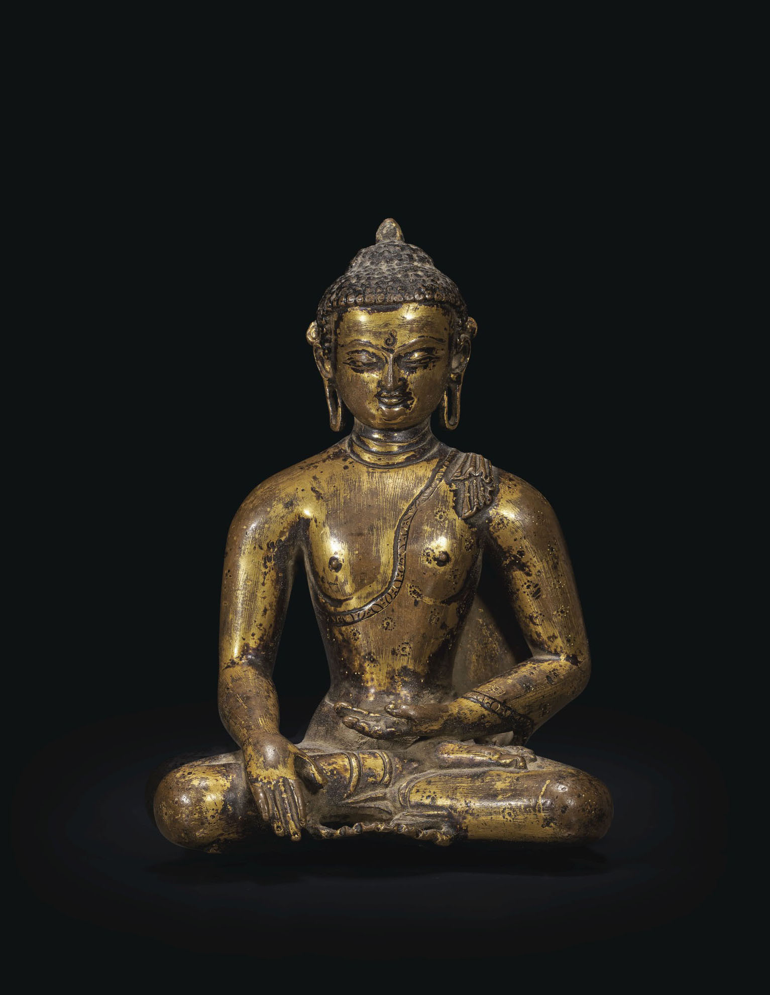 A GILTBRONZE FIGURE OF BUDDHA SHAKYAMUNI , NEPAL, THAKURIEARLY MALLA
