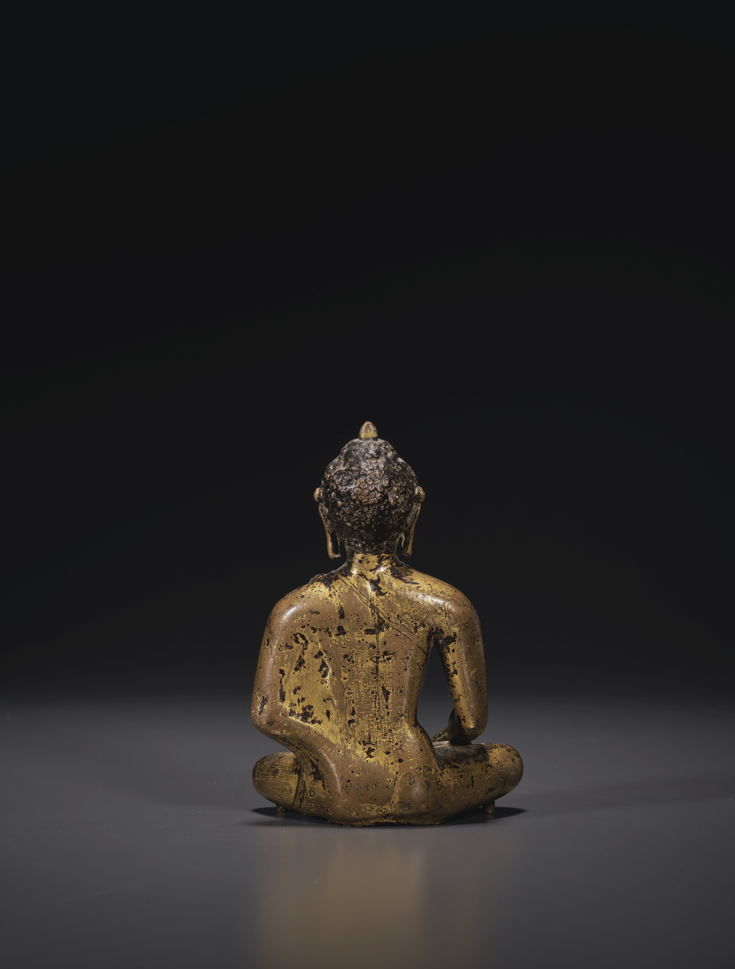 A GILTBRONZE FIGURE OF BUDDHA SHAKYAMUNI , NEPAL, THAKURIEARLY MALLA