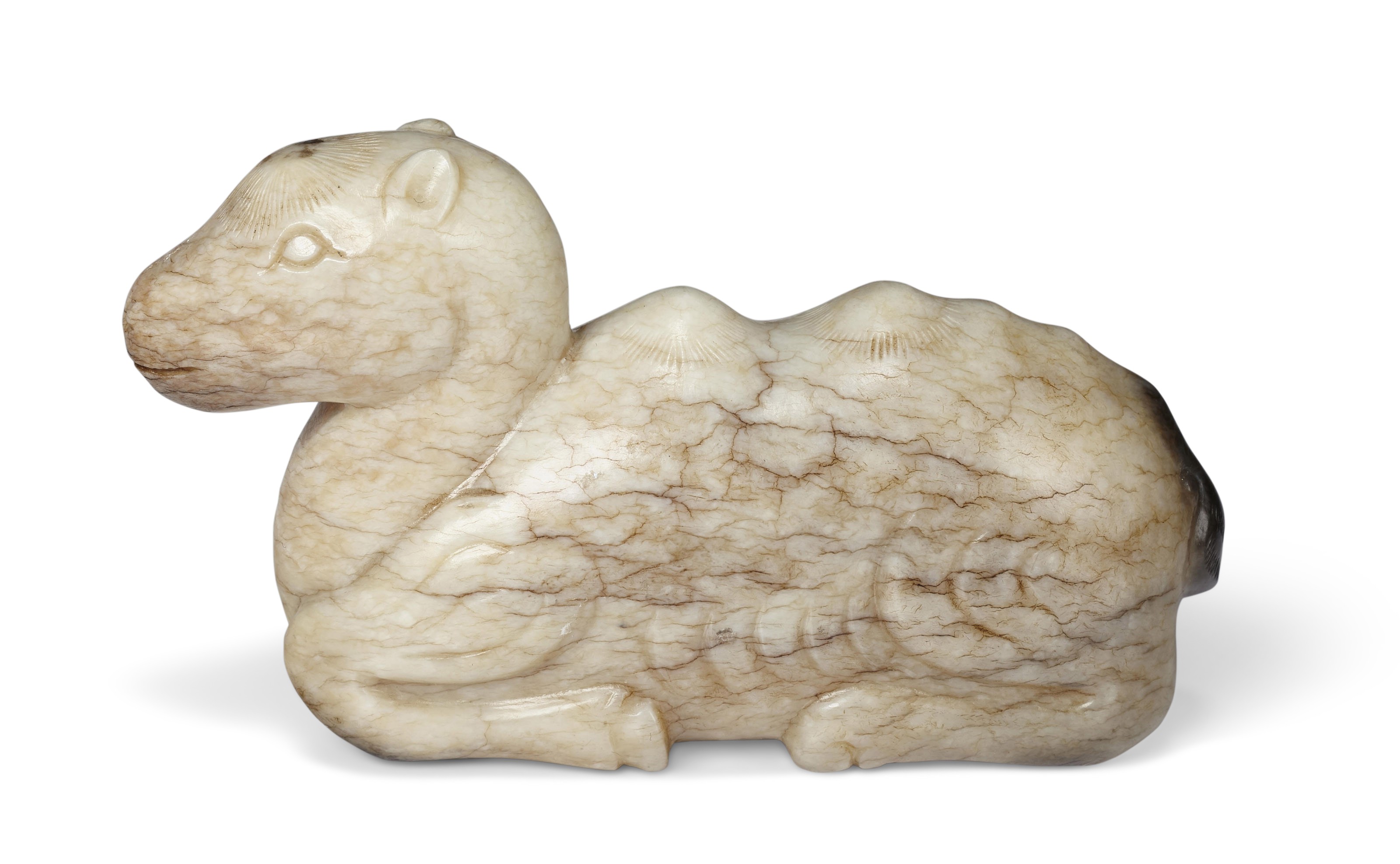 A 'CHICKEN BONE' JADE FIGURE OF A RECUMBENT CAMEL, CHINA, MING