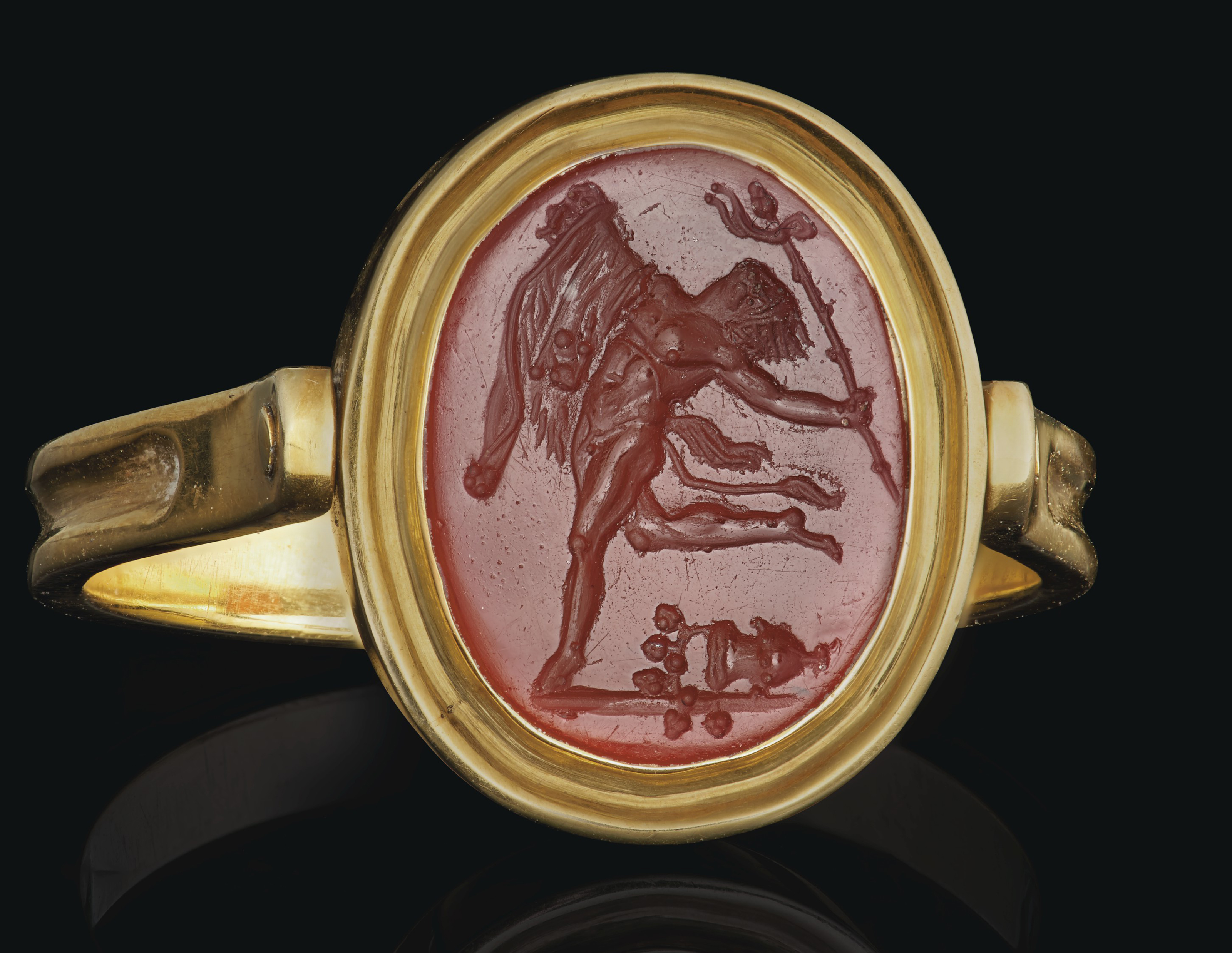 A ROMAN CARNELIAN RINGSTONE WITH A DANCING SATYR, CIRCA 1ST