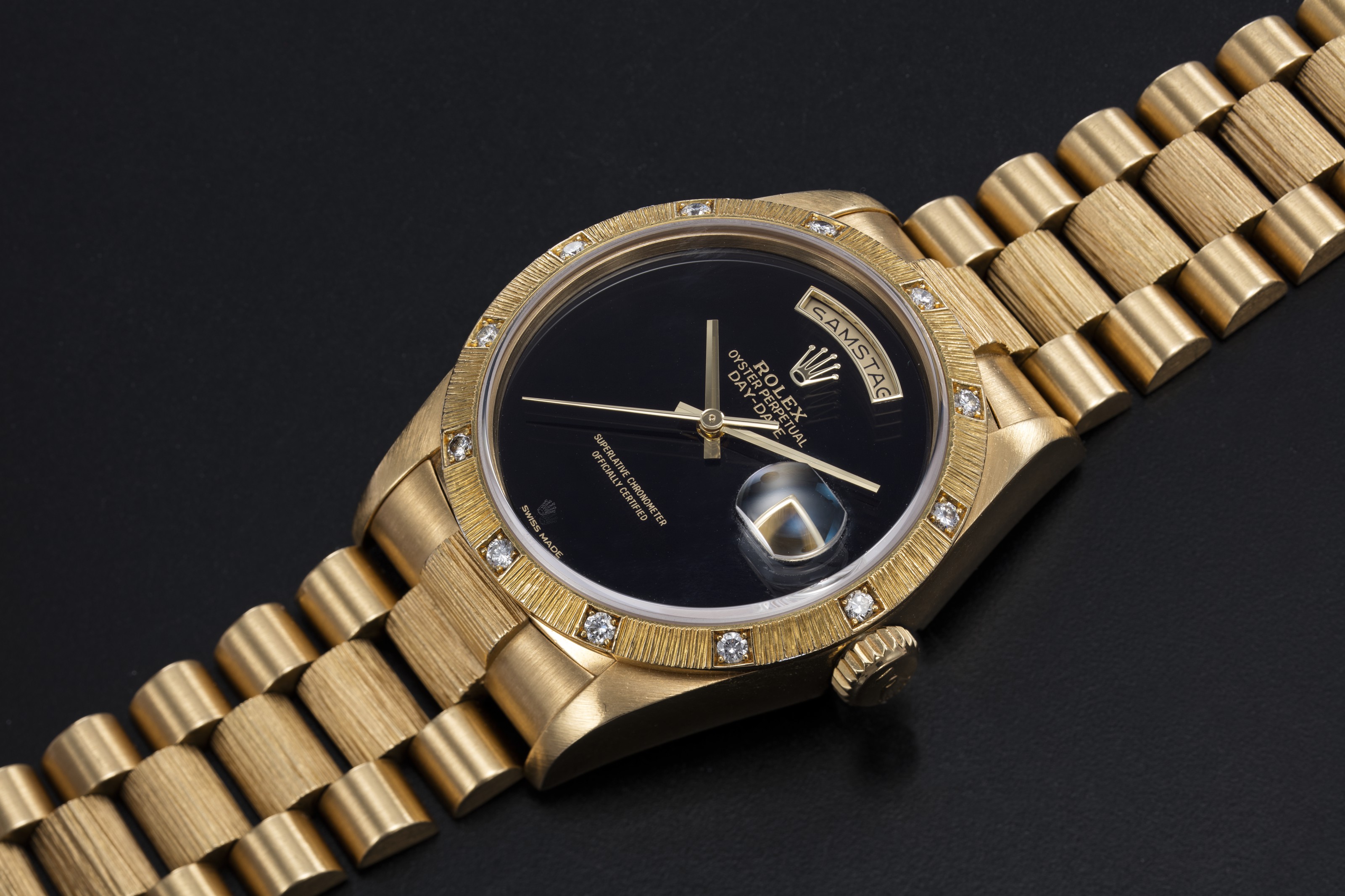 ROLEX, A GOLD OYSTER PERPETUAL DAYDATE WITH DIAMOND BEZEL AND ONYX DIAL, REF. 18108, CASE
