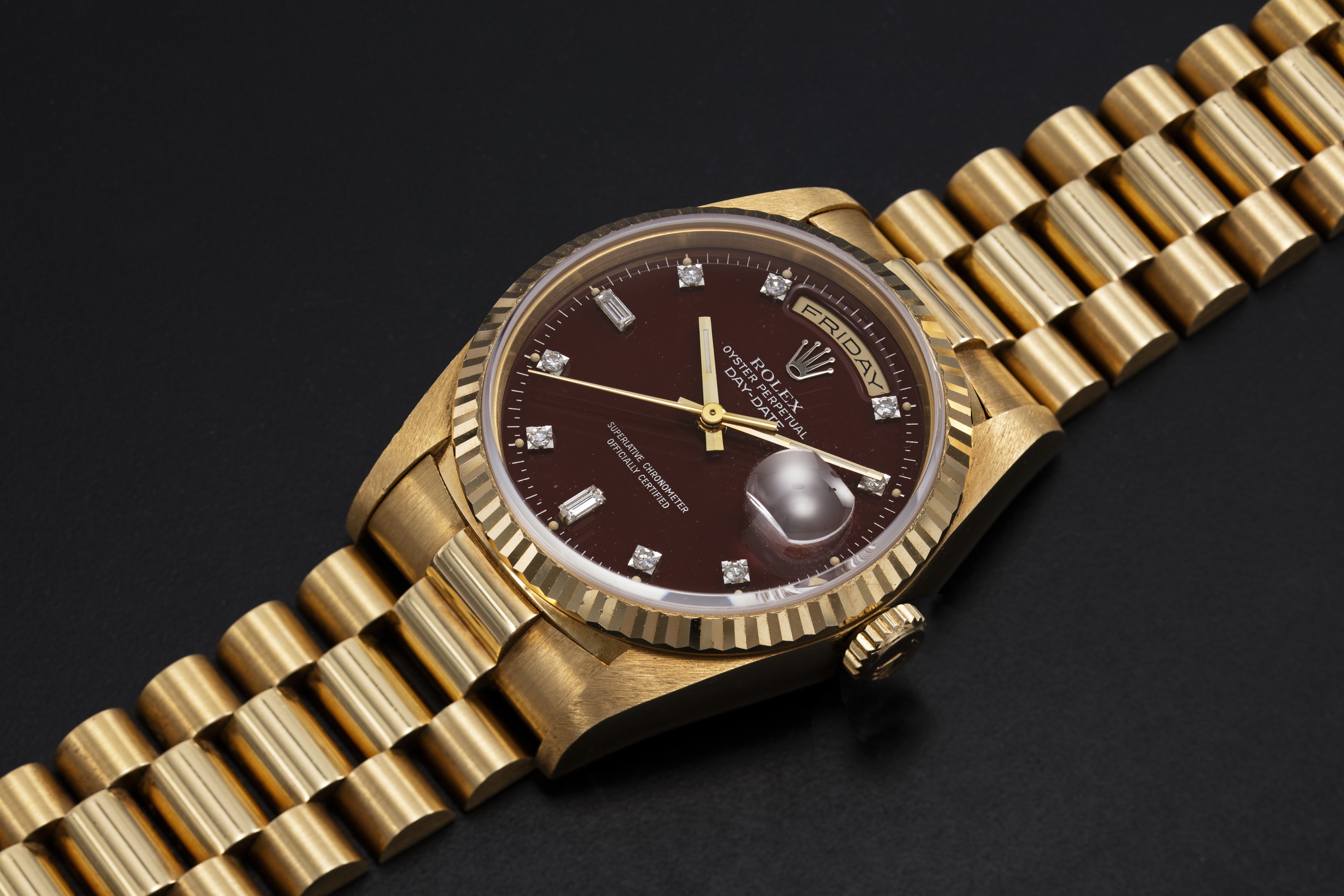 ROLEX, A GOLD OYSTER PERPETUAL DAY-DATE WITH “OXBLOOD STELLA DIAL