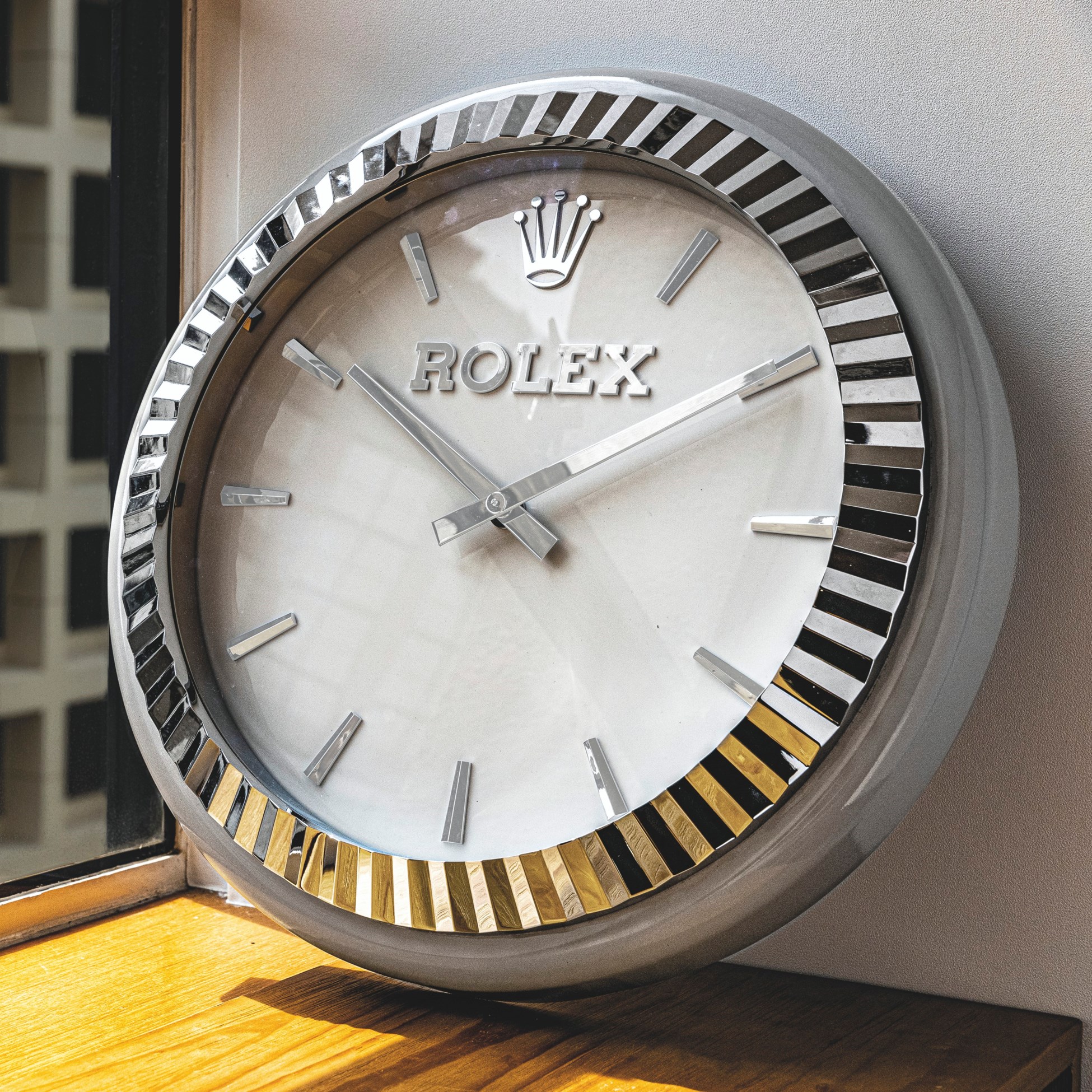 INDUCTA FOR ROLEX. A STAINLESS STEEL QUARTZ WALL CLOCK, SIGNED ROLEX