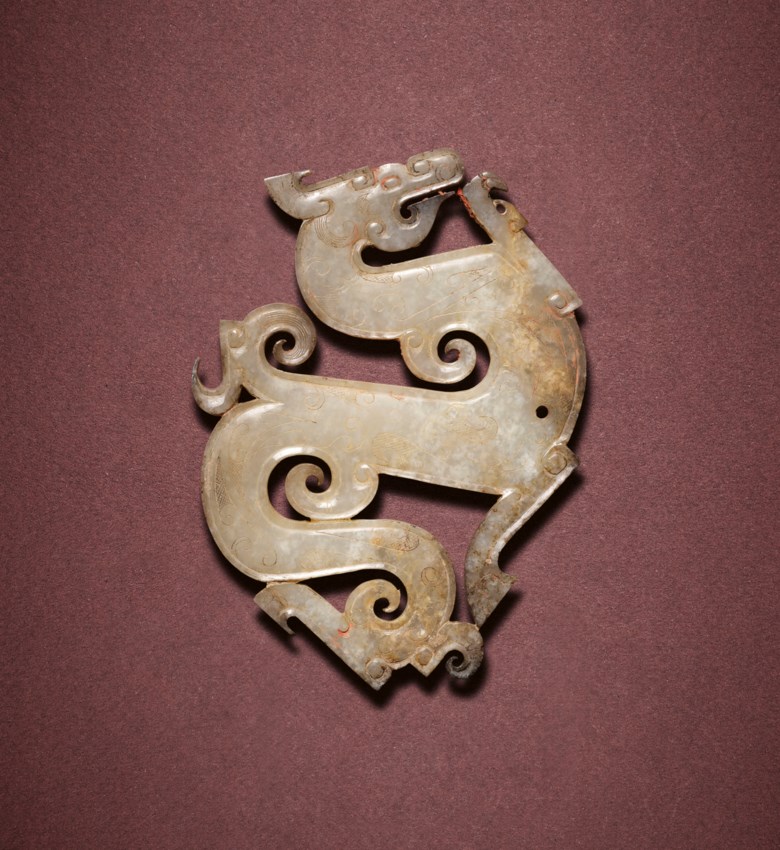 A very rare and finely carved jade dragon-form pendant, Late Warring States period, c. 300-221 BC. 9.1 cm (3⅝ in) long, box. Sold for HK$15,250,000 on 3 December 2021 at Christie’s in Hong Kong