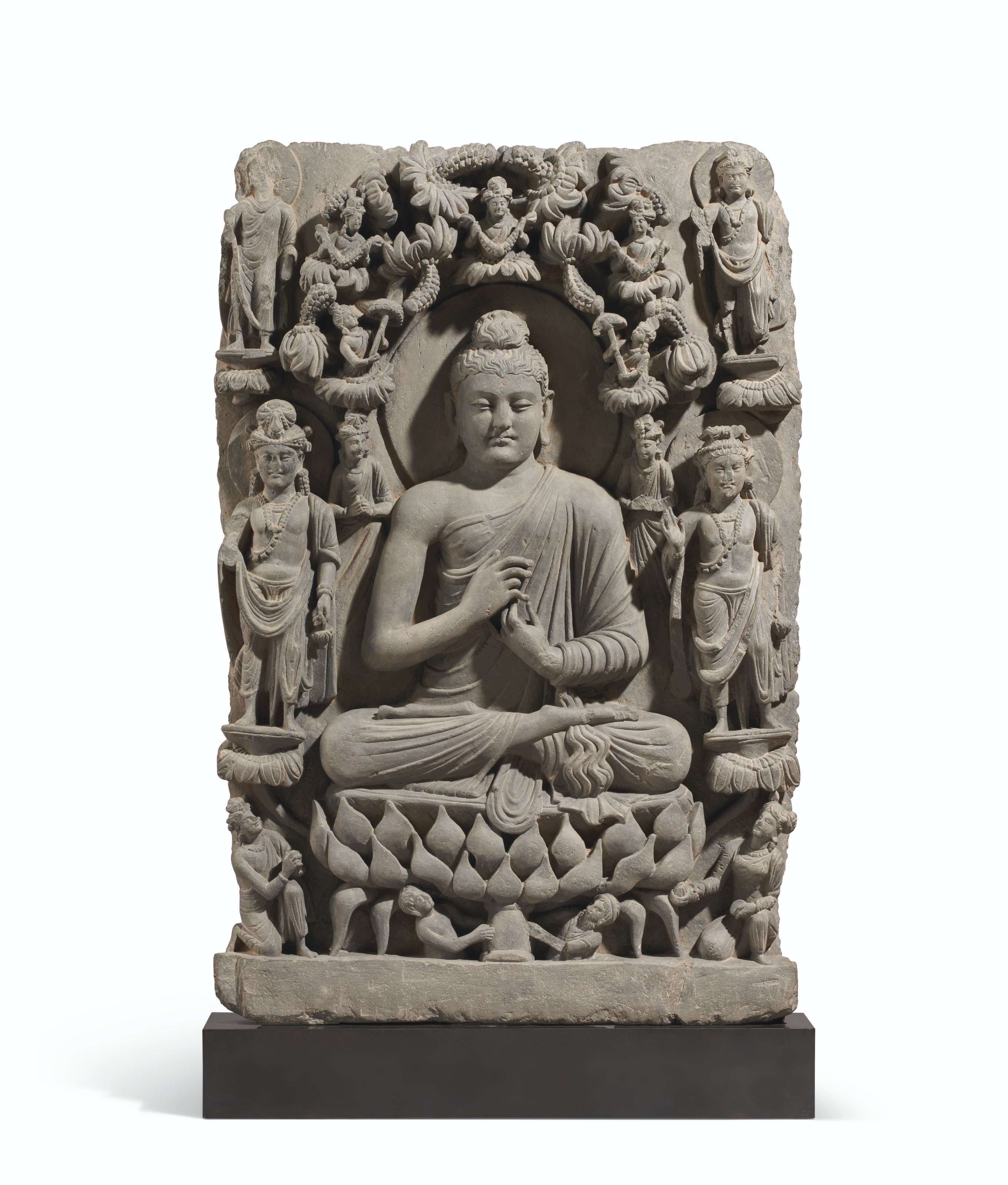 A GRAY SCHIST RELIEF OF BUDDHA FLANKED BY BODHISATTVAS, ANCIENT REGION ...
