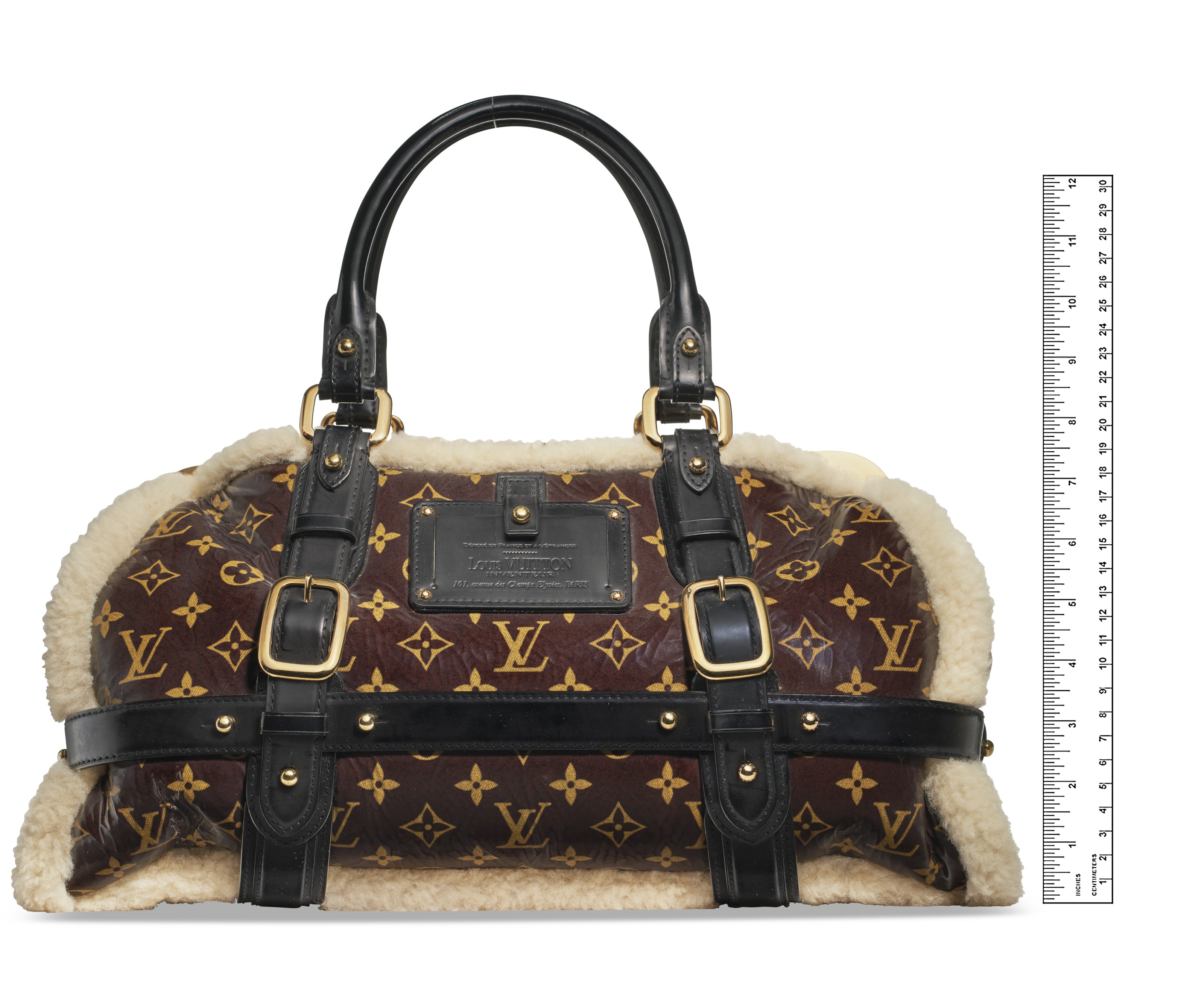 A BROWN MONOGRAM SHEARLING STORM BAG WITH GOLD HARDWARE LOUIS