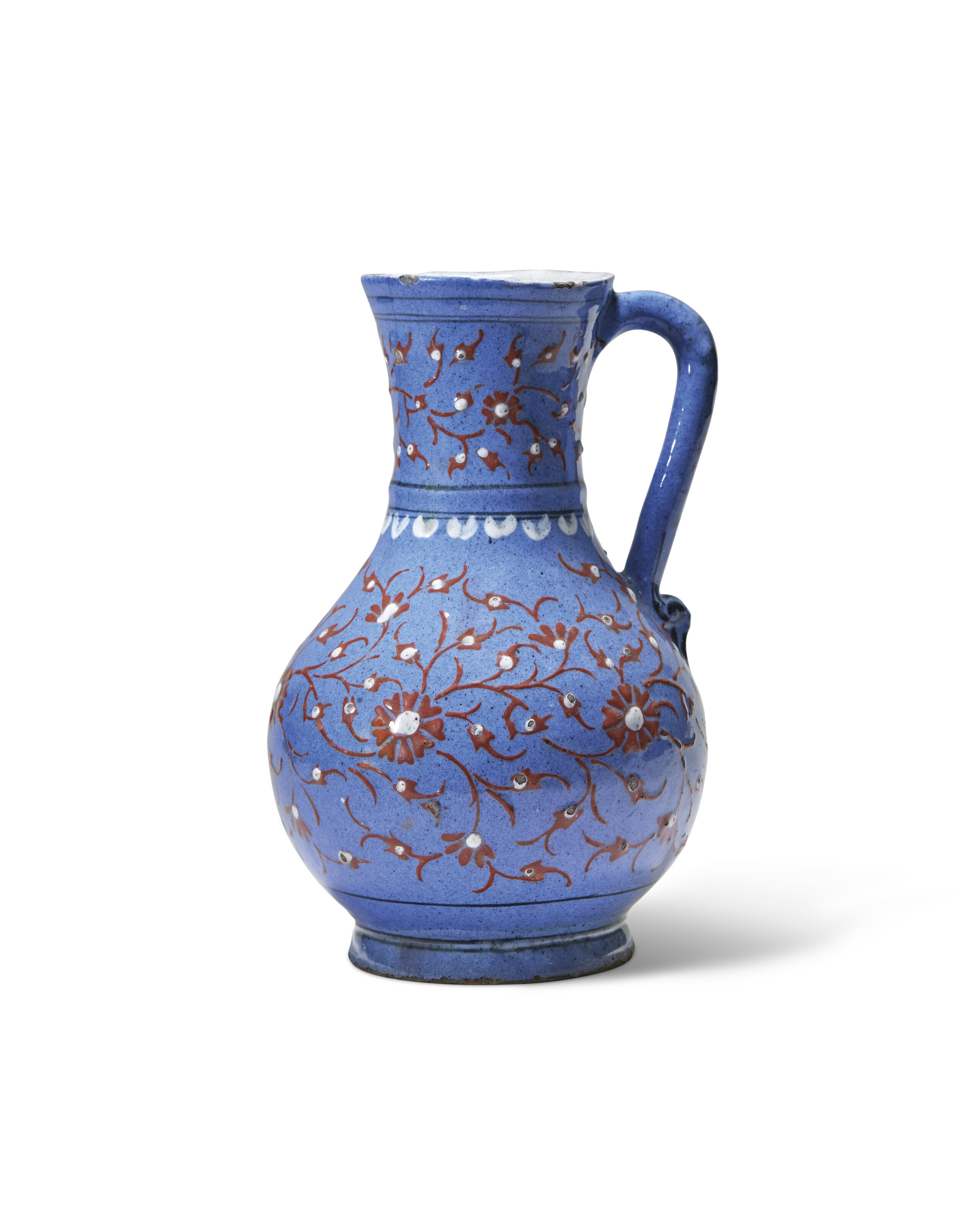 An Iznik lavender ground slip painted pottery jug, Ottoman turkey, circa 1570, the lavender-blue ground decorated in bole-red, white and black with a floral design, the interior and base white with a clear glaze, sold for £906,000 on 27 October 2022 at Christie's in London