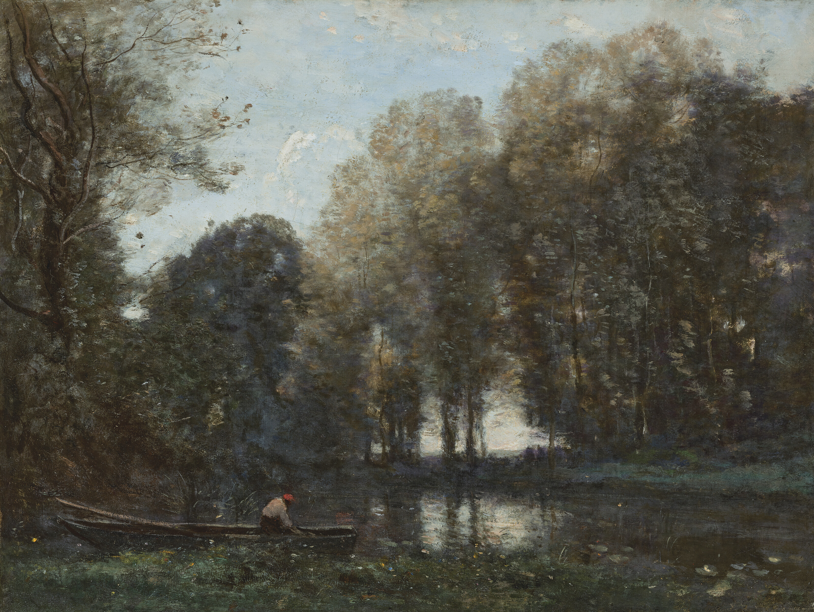 Pêcheur amarré sur la rive verte