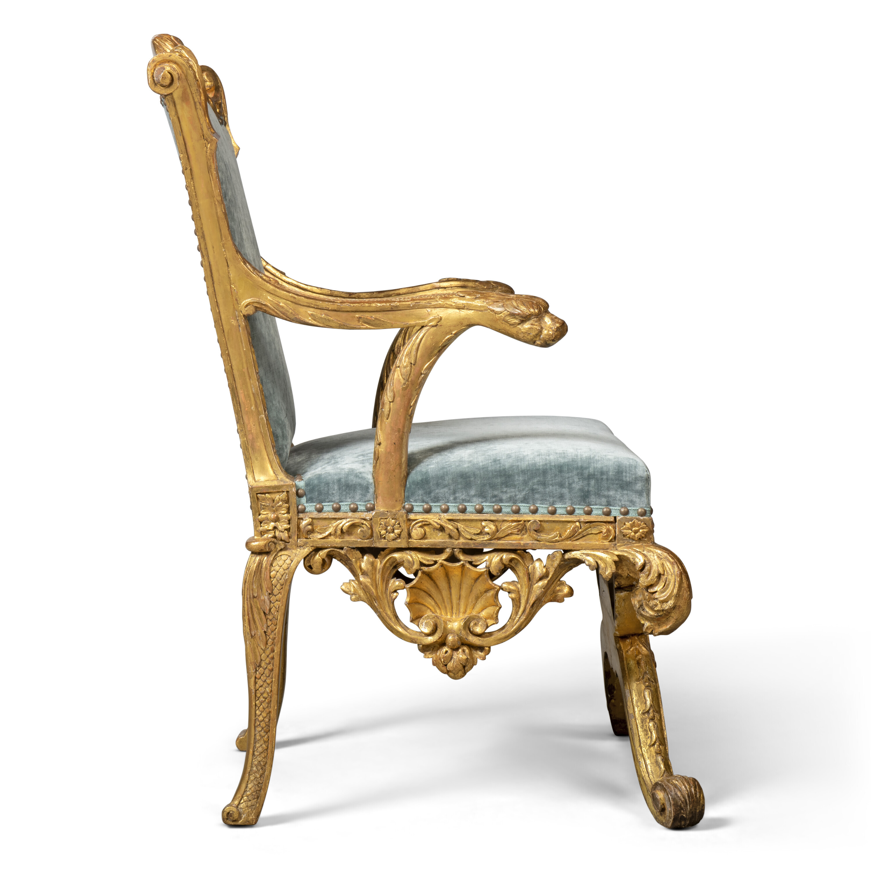 A GEORGE II GILT WALNUT ARMCHAIR, IN THE MANNER OF WILLIAM KENT
