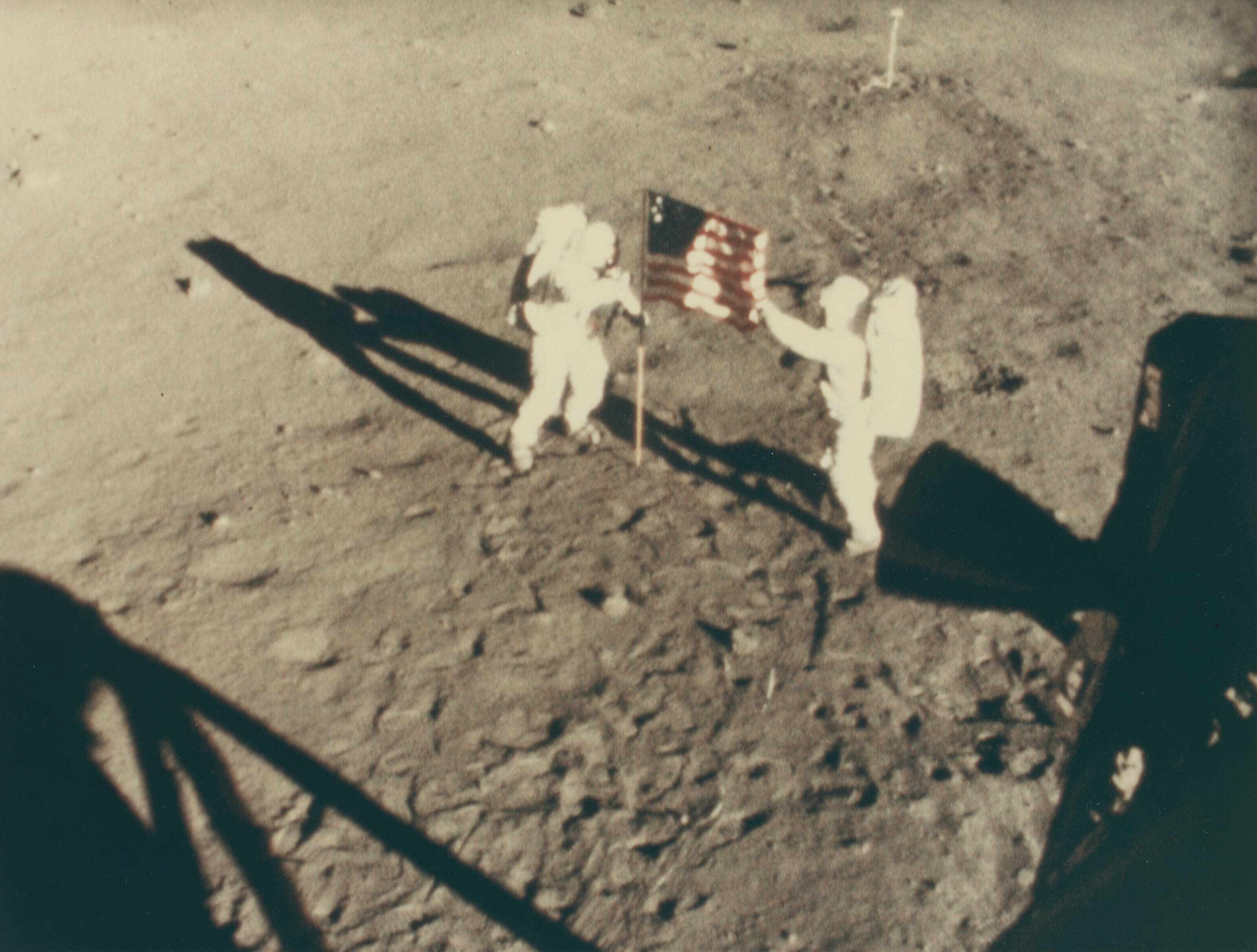 The astronauts planting the American flag on the lunar surface, 16-24 July 1969, NASA (camera on Apollo 11). Taken by an automatic 16mm camera mounted to the window of Eagle. 20.3 x 25.4 cm (8 x 10 in). Sold for &pound;630 on 18 May 2022 at Christie&rsquo;s Online