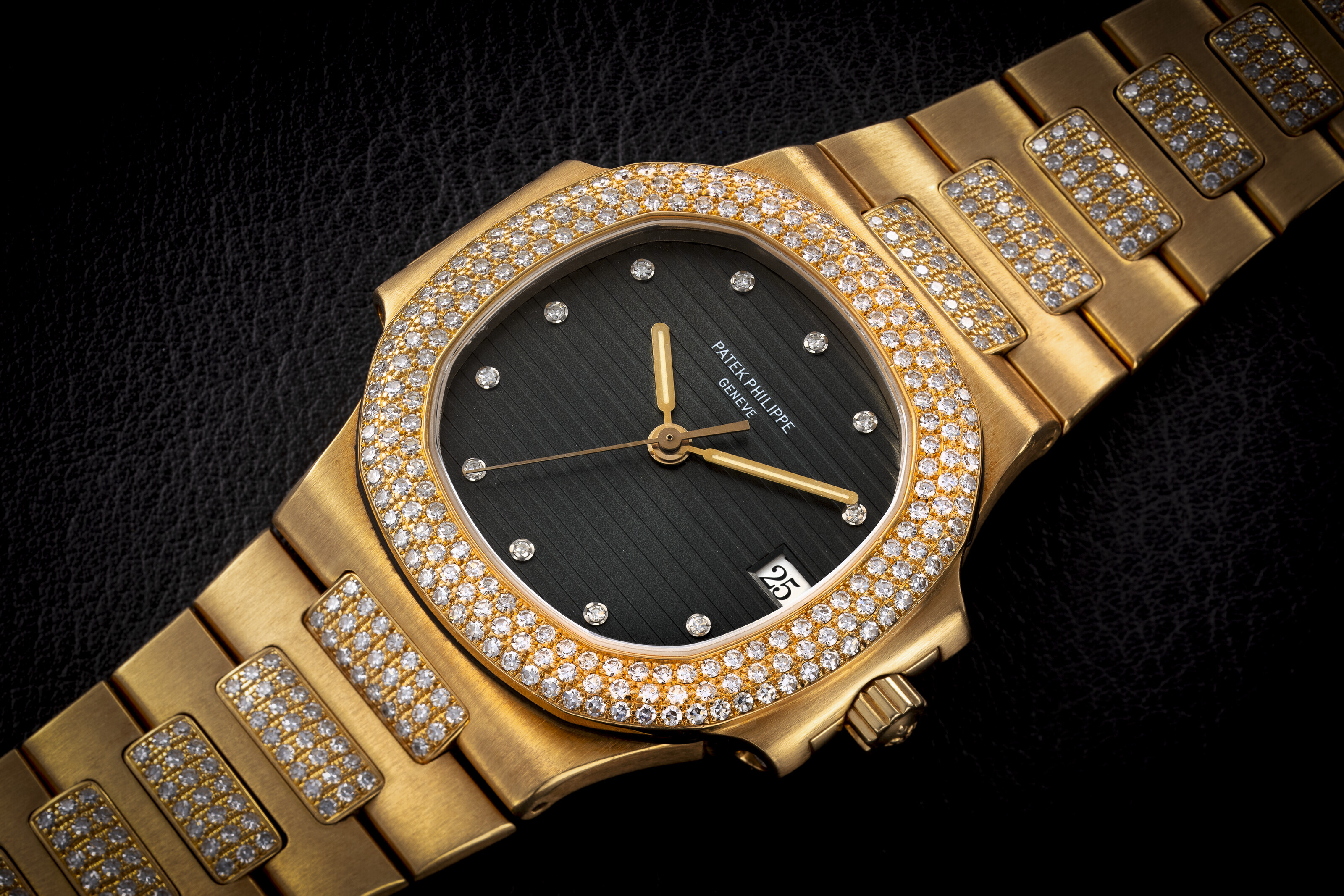 PATEK PHILIPPE NAUTILUS REF. 3800 5 A RARE GOLD AND DIAMOND SET AUTOMATIC WRISTWATCH