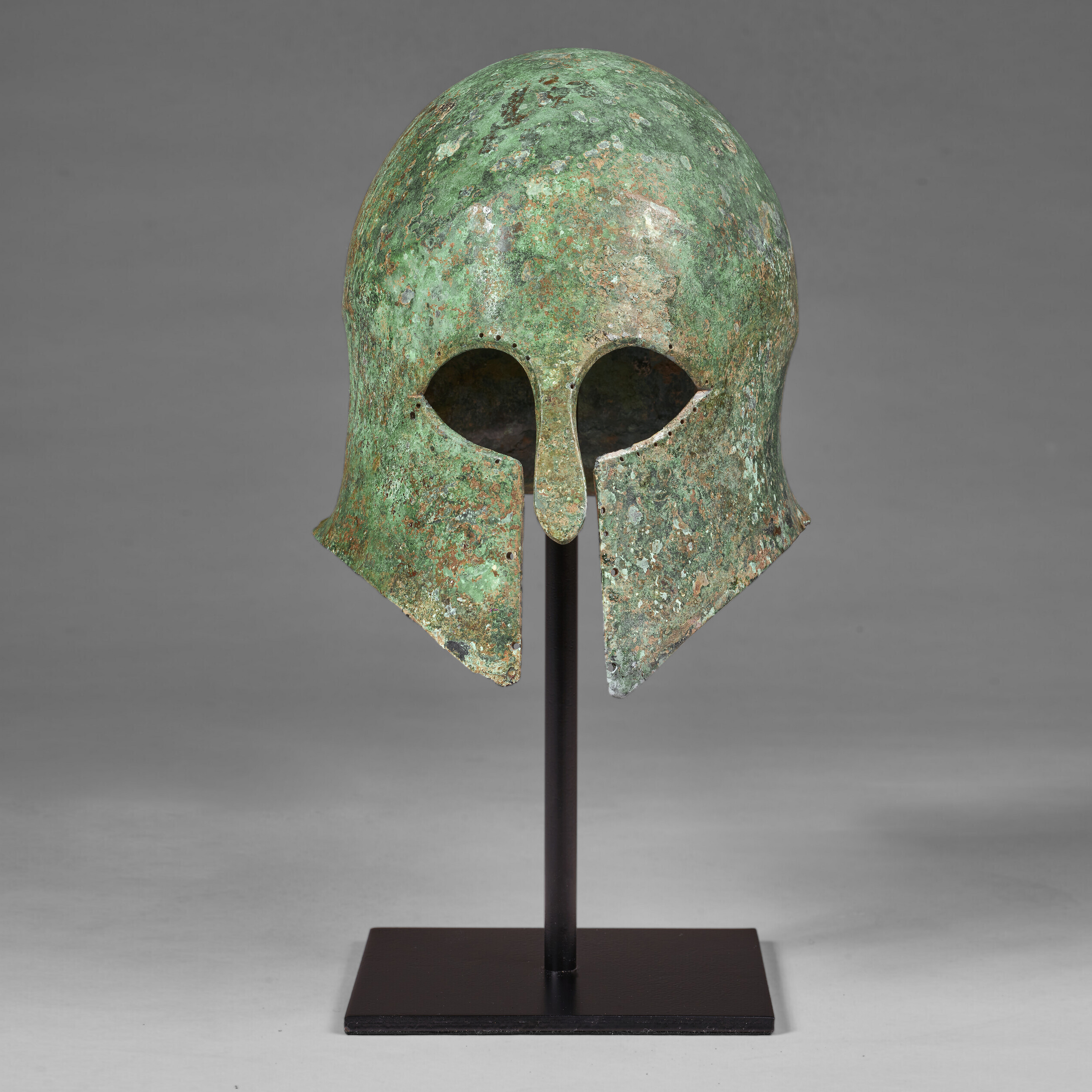 A GREEK BRONZE CORINTHIAN HELMET, LATE ARCHAIC PERIOD TO EARLY
