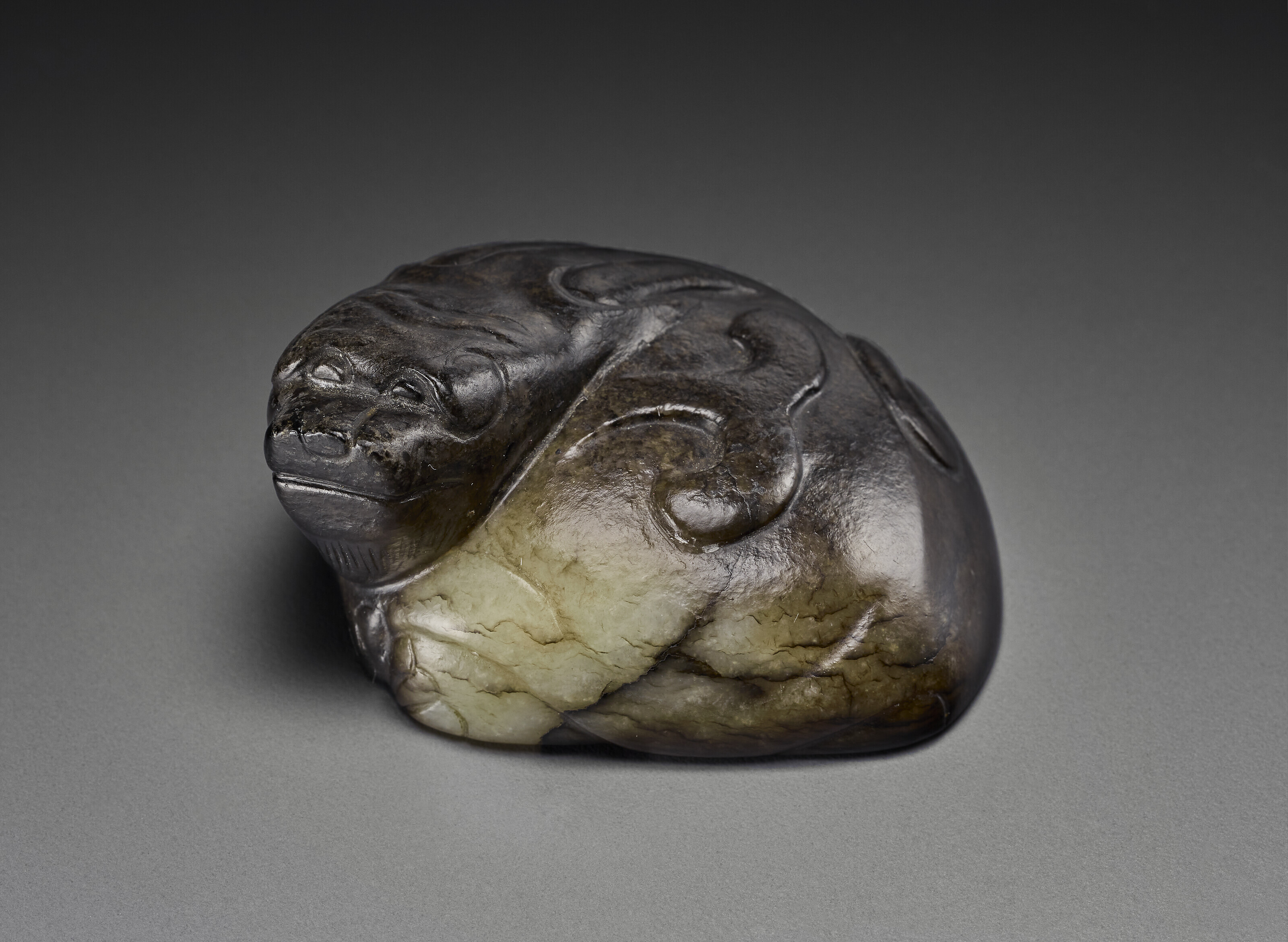 A SUPERB YELLOW JADE FIGURE OF A RECUMBENT MYTHICAL BEAST