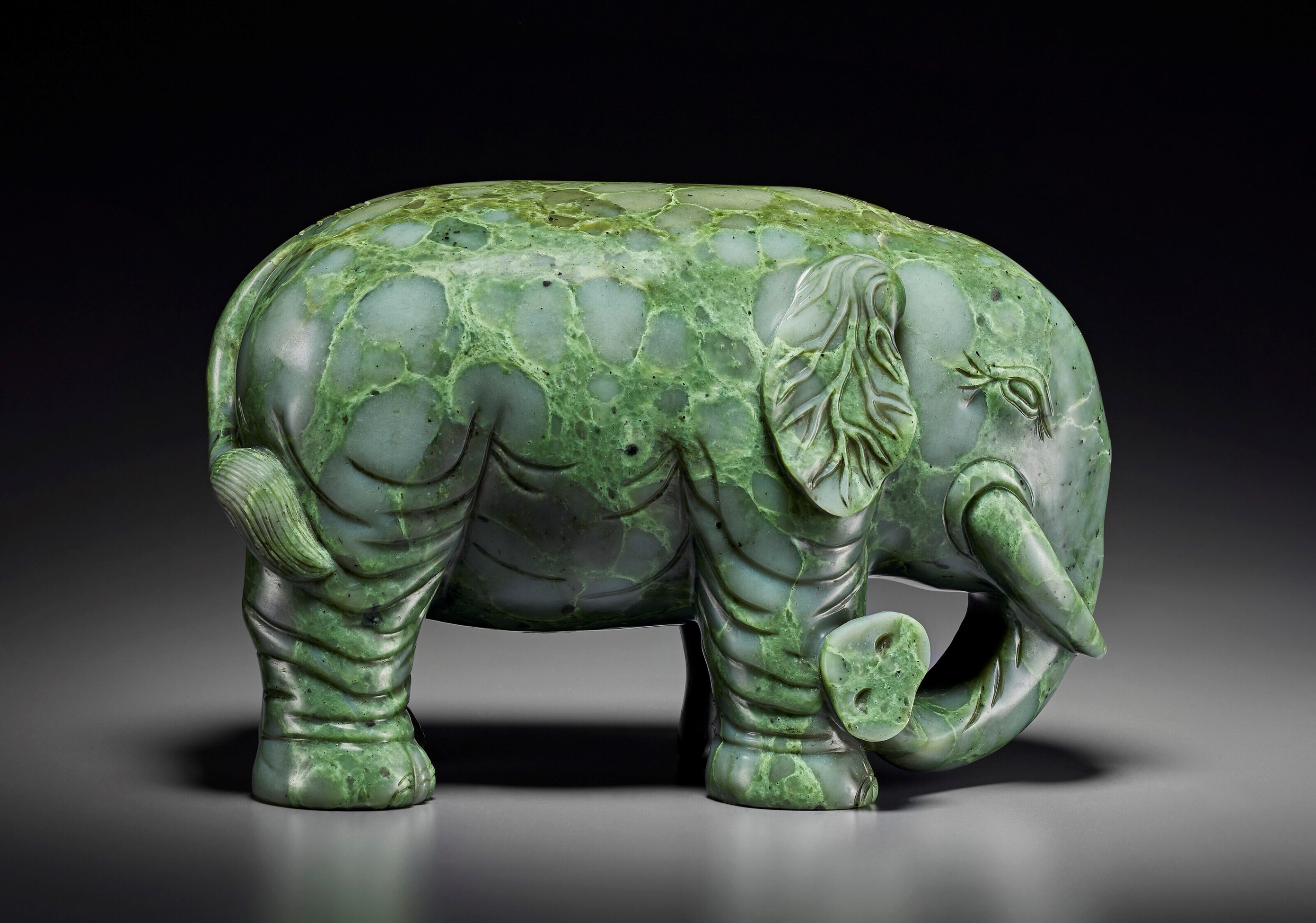 A SUPERB LARGE SPINACHGREEN JADE FIGURE OF AN ELEPHANT, QIANLONG