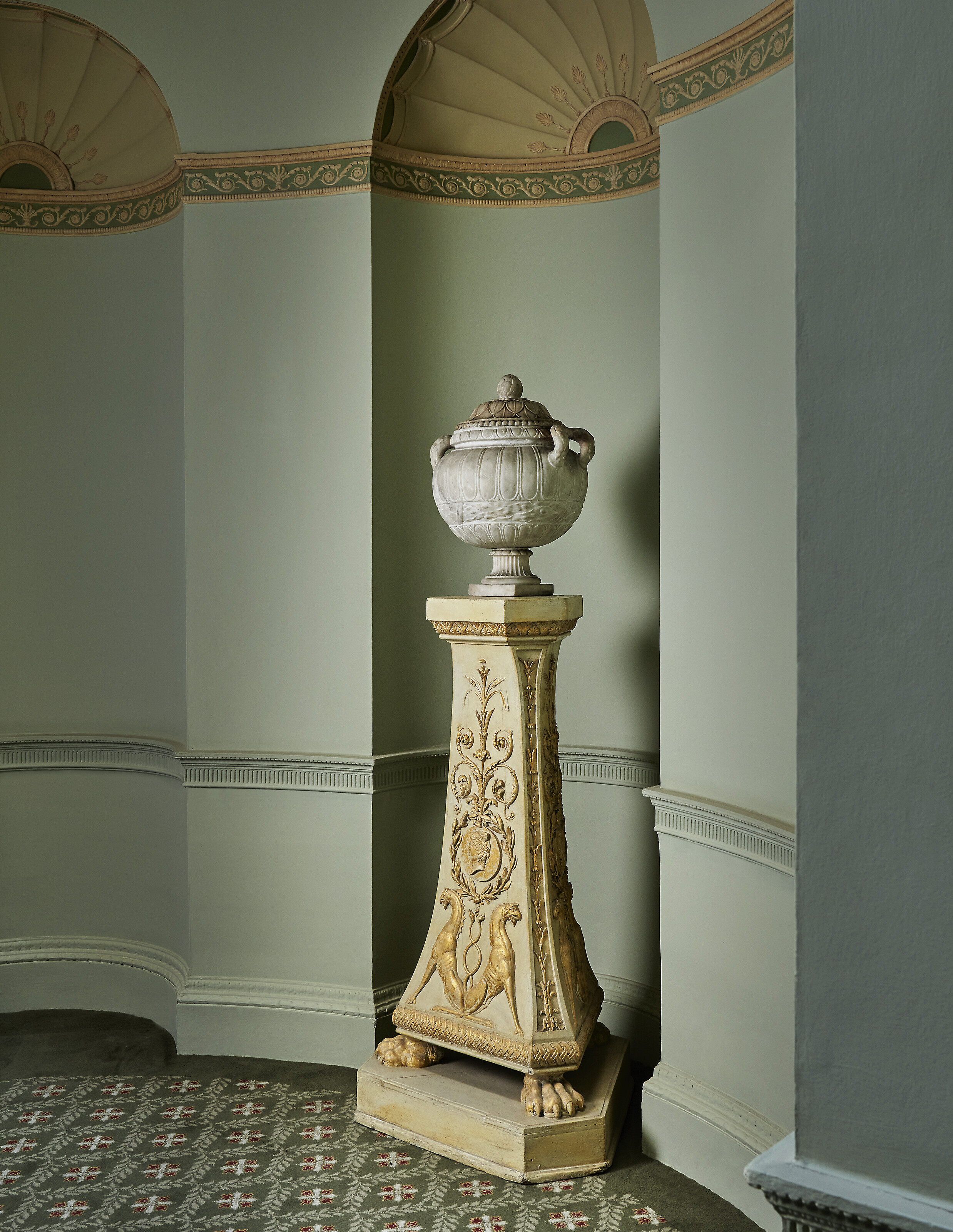 A GEORGE III WHITE-PAINTED AND PARCEL-GILT PEDESTAL, AFTER THE
