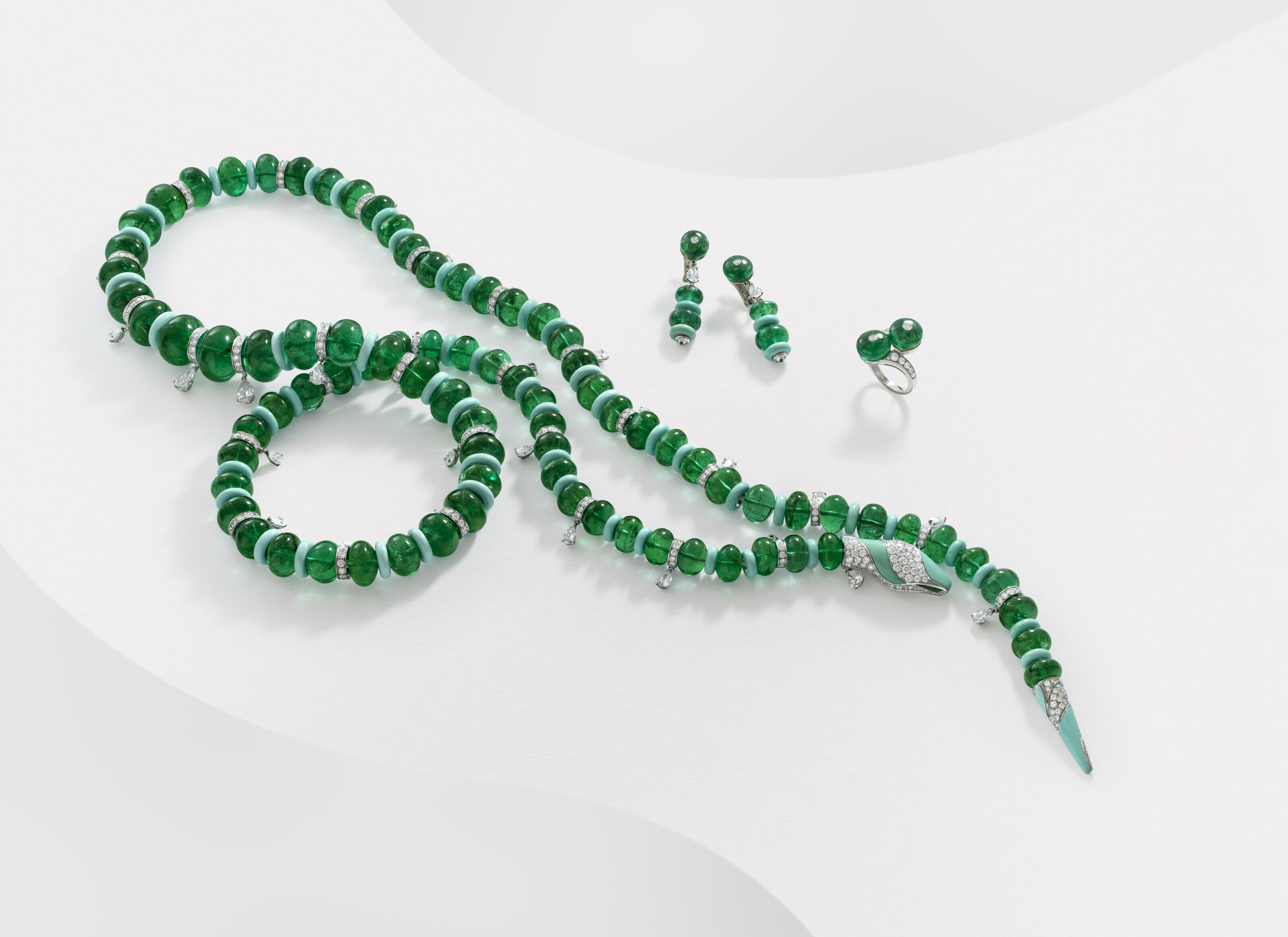 A Rare Bulgari suite of emerald, turquoise and diamond jewellery, comprising a snake necklace, a pair of earrings and a ring. Size/dimensions: necklace 106.2 cm; earrings 4.0 cm; US ring size 6. Sold for CHF1,033,200 on 10 May 2023 at Christie’s in Geneva