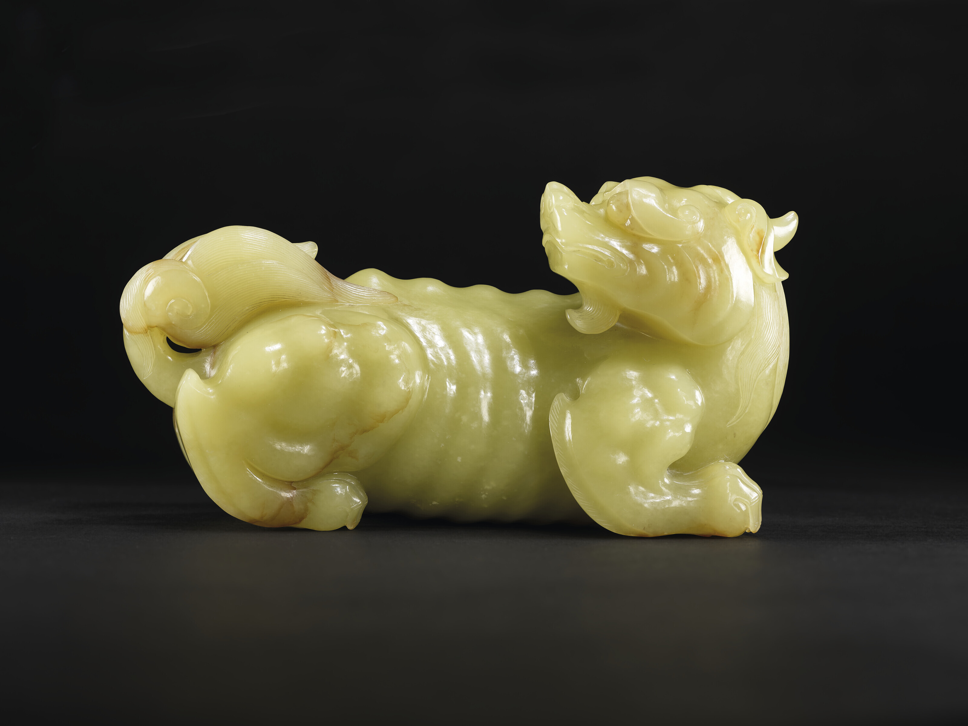 A VERY RARE LARGE YELLOW JADE CARVING OF A XIEZHI, QIANLONG PERIOD