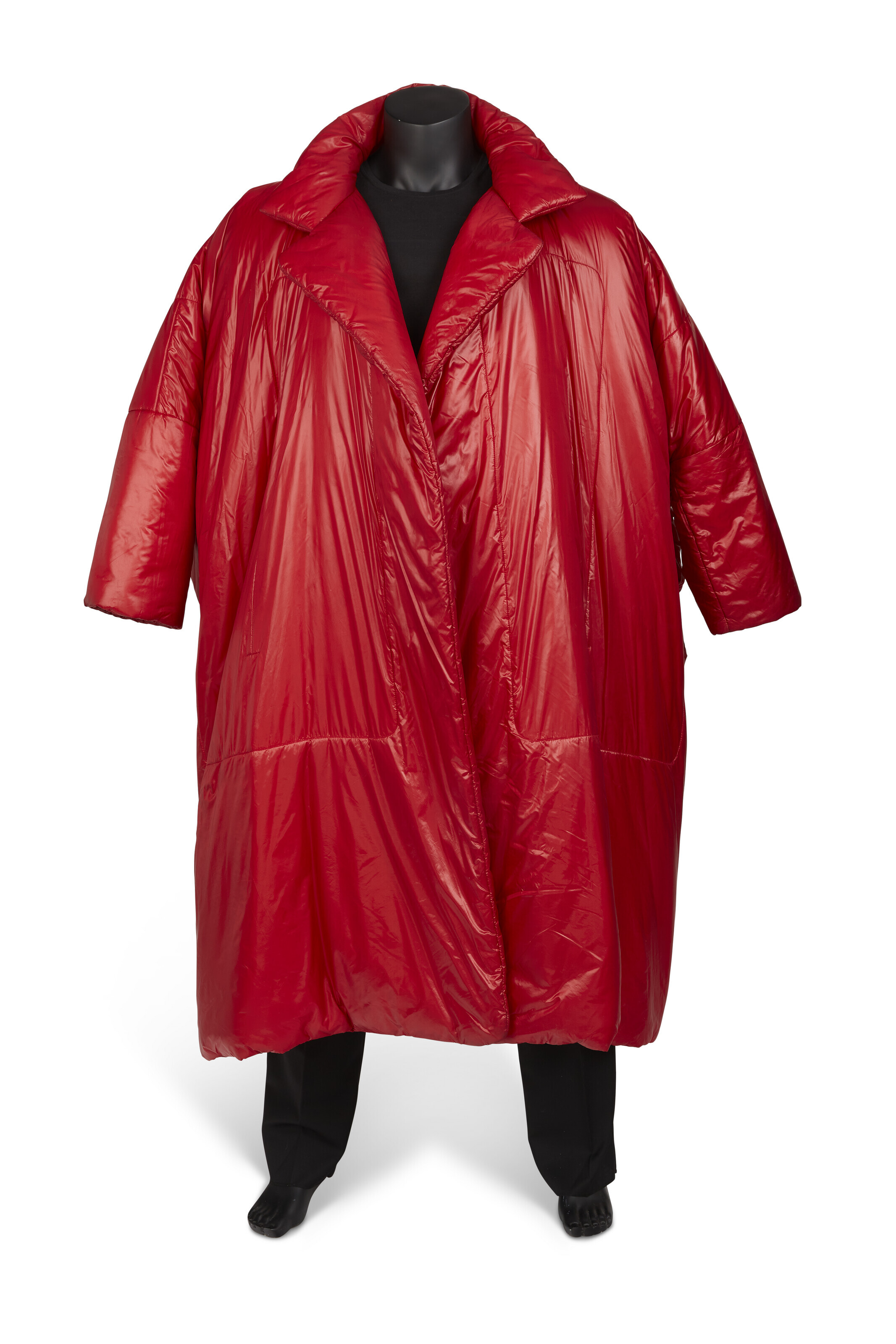Norma Kamali, a brick red &lsquo;sleeping bag&rsquo; clutch coat, 2000s. Reversible, in rip-stop weave nylon with notch lapel and side slit inset pockets. Medium. Sold for $25,200 on 15 February 2023 at Christie's in New York