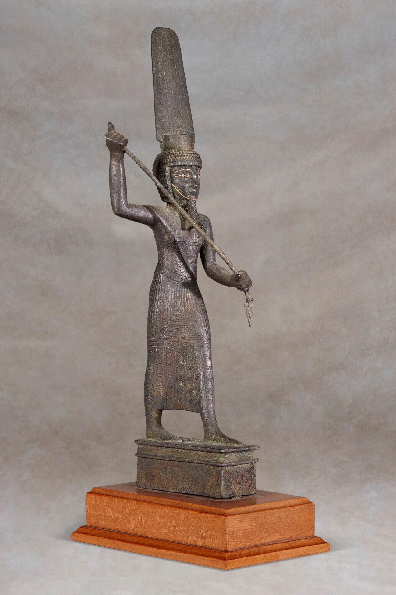 AN EGYPTIAN GOLD-INLAID BRONZE ONURIS, LATE PERIOD, 664-332 B.C ...