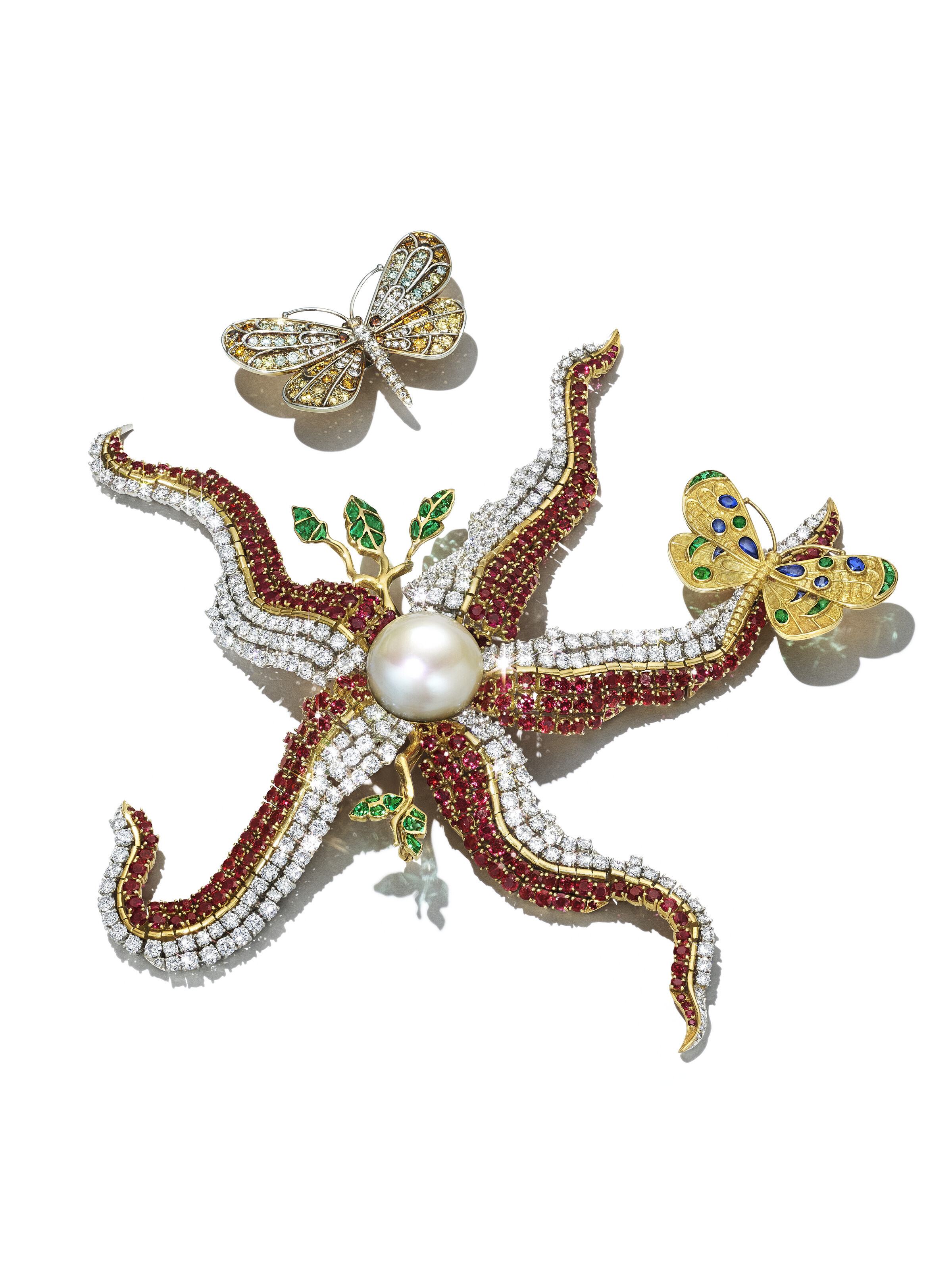 An iconic Salvador Dal&iacute; '&eacute;toile de mer' cultured pearl, ruby, diamond and emerald brooch. 17.5 x 16.2 cm (6⅞ x 6⅜ in); larger butterfly enhancement 4.8 x 3.8 cm (1⅞ x 1&frac12; in); smaller butterfly enhancement 4.1 x 3.2 cm (1⅝ x 1&frac14; in). Sold for $982,800 in Magnificent Jewels on 7 June 2023 at Christie&rsquo;s in New York