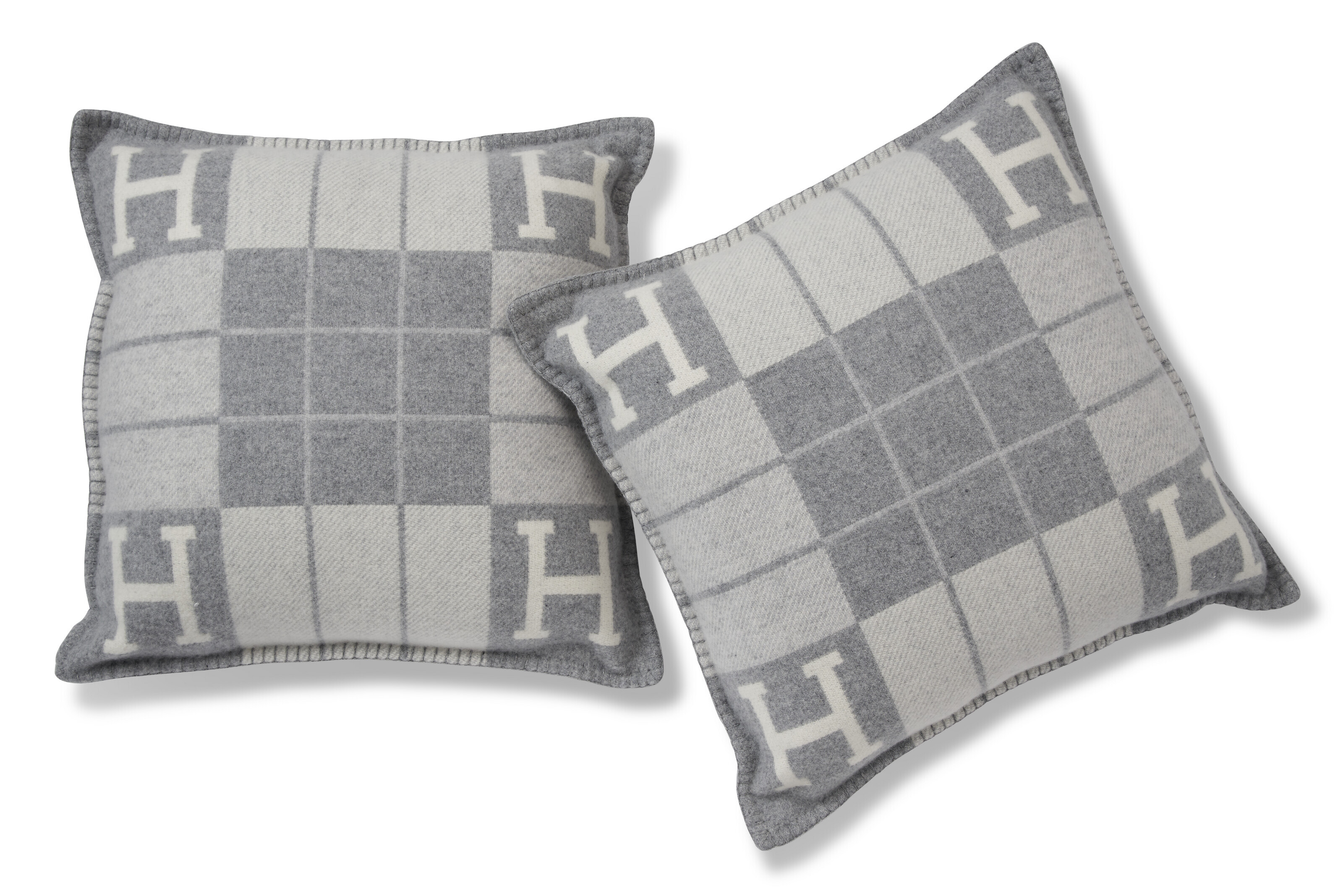 A SET OF TWO GRIS CLAIR & ÉCRU CASHMERE AND WOOL AVALON III PILLOWS, HERMÈS, 2023 Christie’s