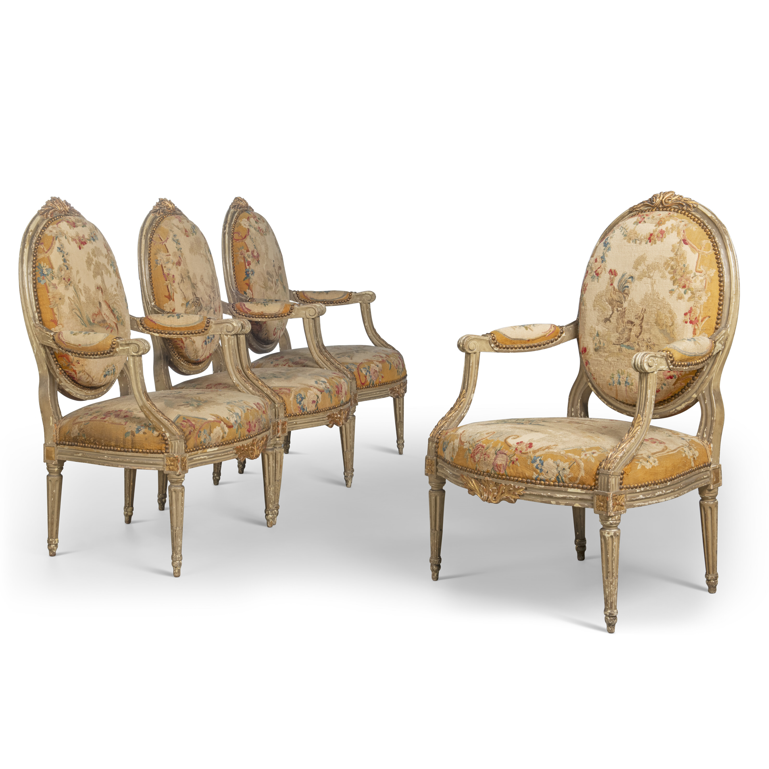 A SET OF FOUR LOUIS XVI PARCEL-GILT AND GREY-PAINTED FATEUILS