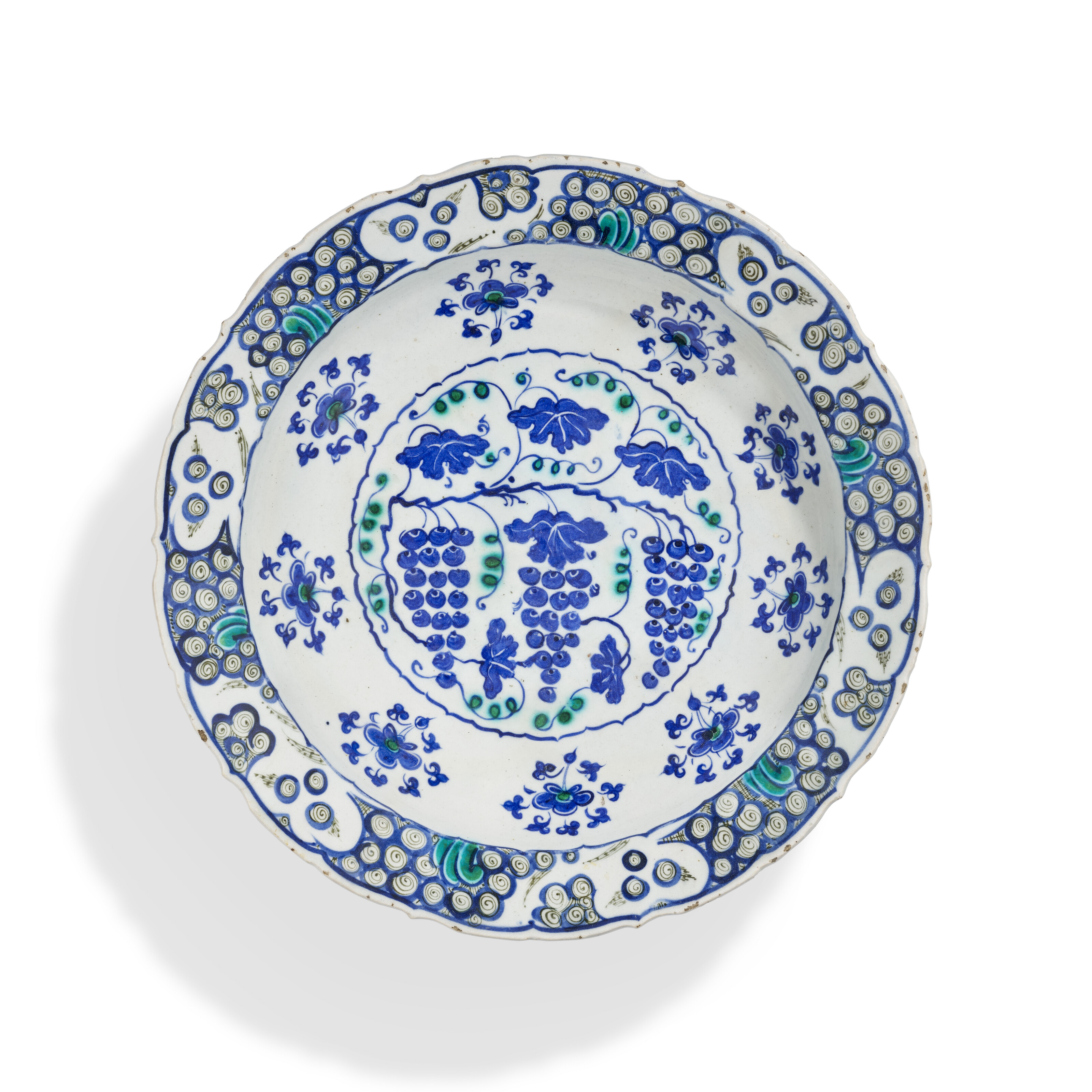 A large Iznik pottery Grape dish, Ottoman Turkey, circa 1570, offered in Art of the Islamic and Indian Worlds including Rugs and Carpets on 24 October 2024 at Christie's in London