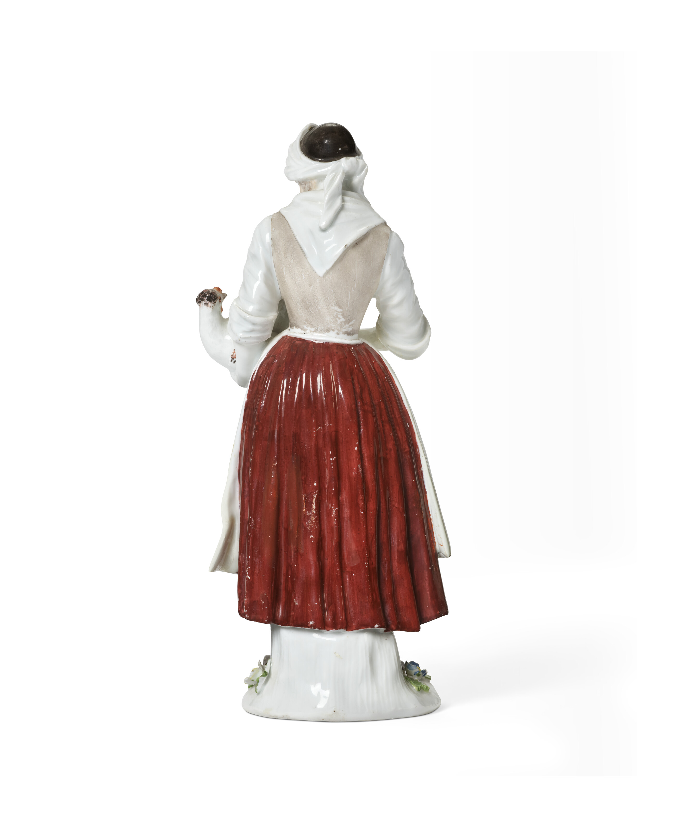 A MEISSEN PORCELAIN FIGURE OF A PEASANT WOMAN WITH A HEN, CIRCA