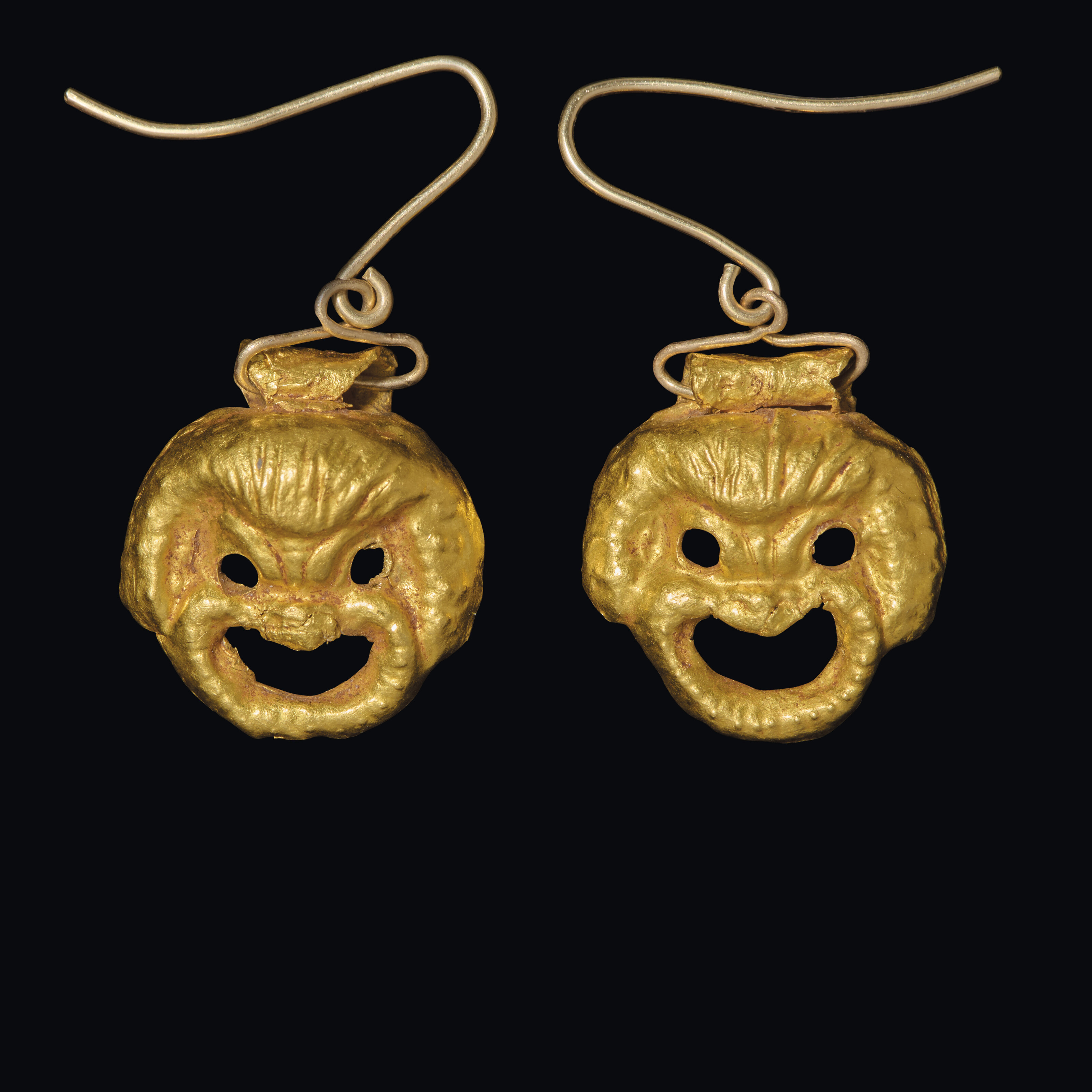 A pair of Greek gold theater mask pendants, Hellenistic period, circa 3rd-1st century BC, offered in Works of Art from the Mougins Museum of Classical Art, Online from 26 November to 10 December 2024 at Christie's Online