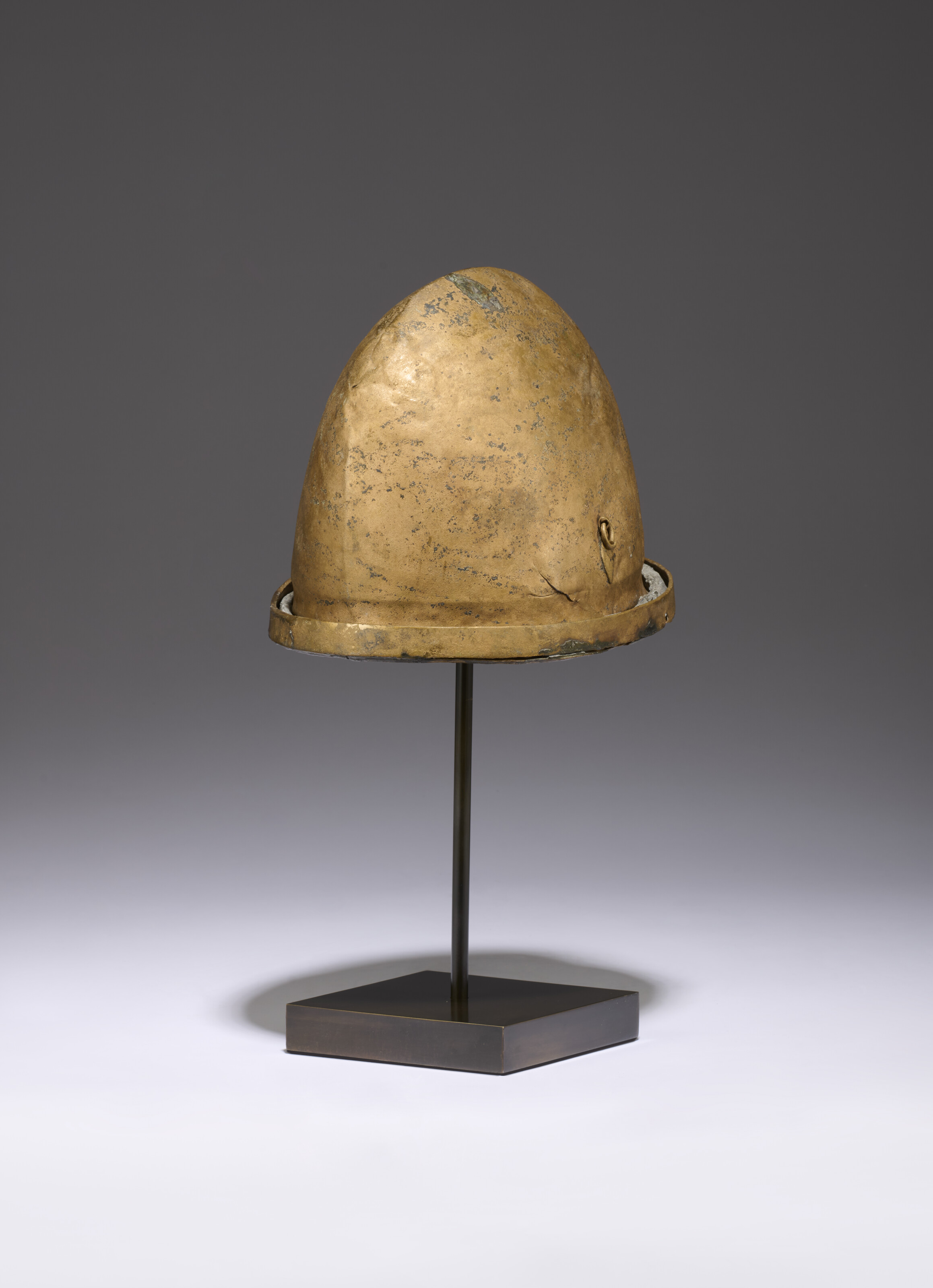 AN ETRUSCAN BRONZE HELMET OF NEGAU TYPE, CIRCA 5TH CENTURY B.C.