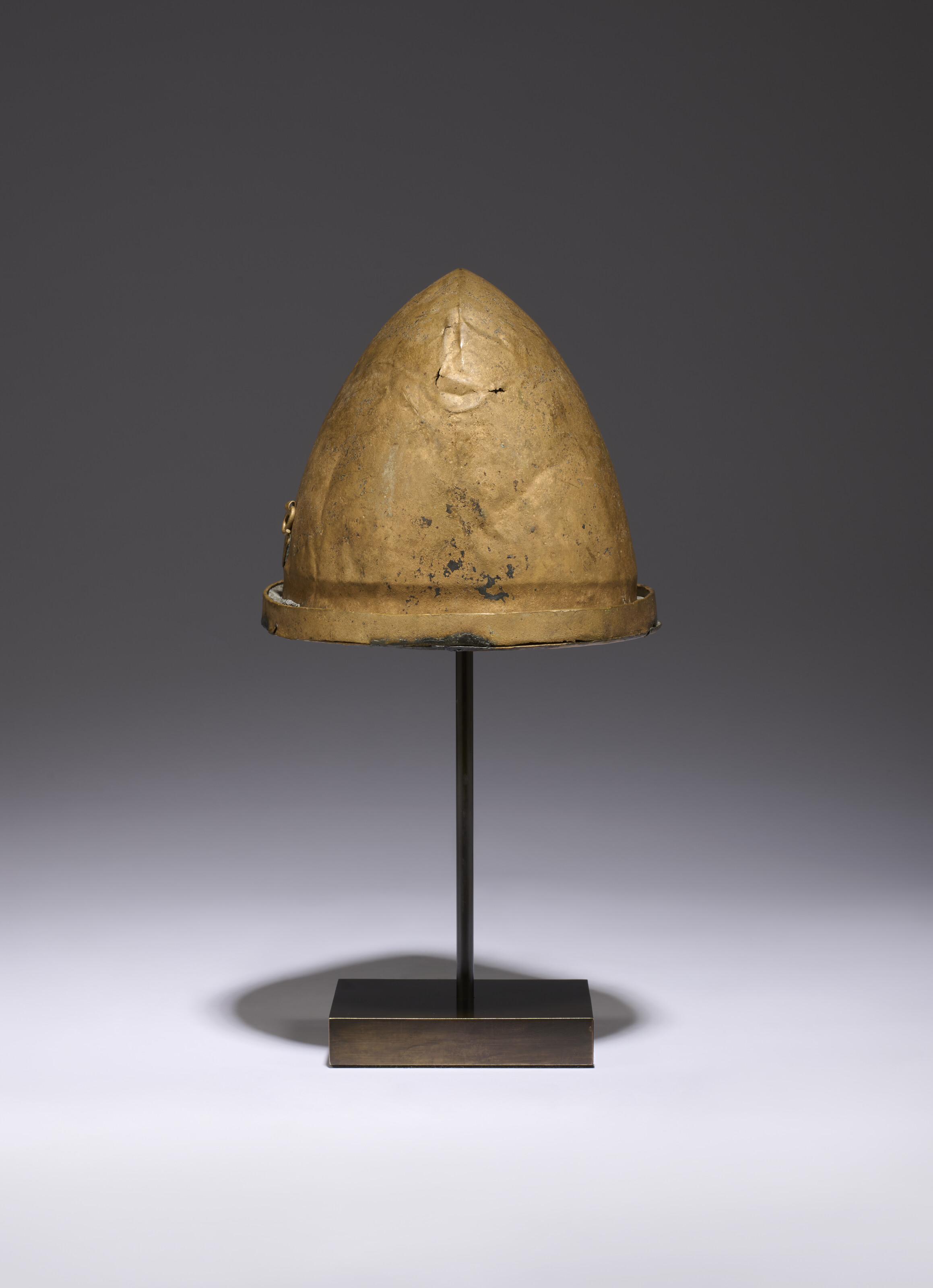 AN ETRUSCAN BRONZE HELMET OF NEGAU TYPE, CIRCA 5TH CENTURY B.C.