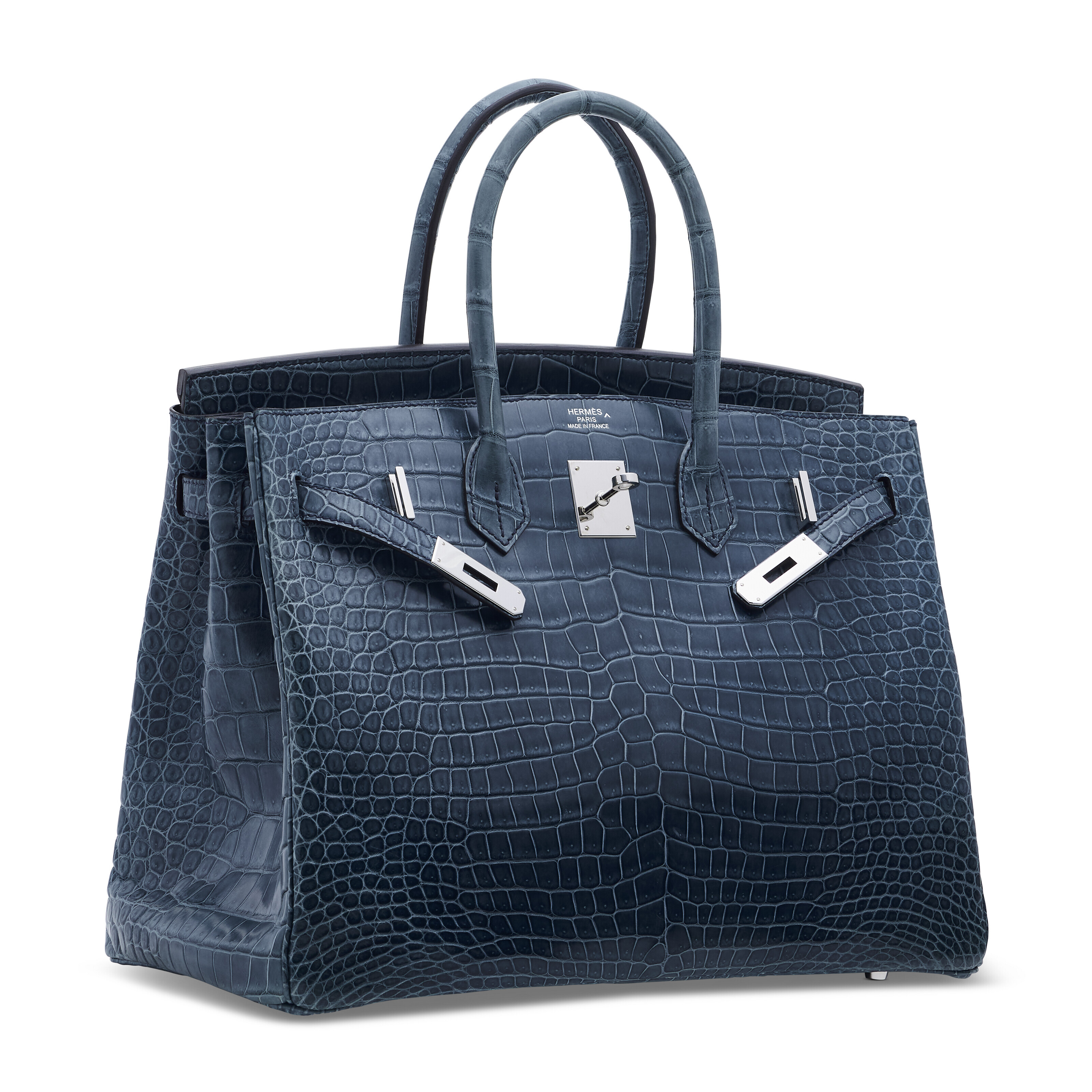 A matte Bleu Tempete Porosus crocodile Birkin 35 with palladium hardware, Hermes, 2014, sold for HK$252,000 on 25 May 2024 at Christie's in Hong Kong. The three-line stamp on front of the bag is coloured to match the hardware, and the caret symbol (^) denotes Porosus crocodile skin