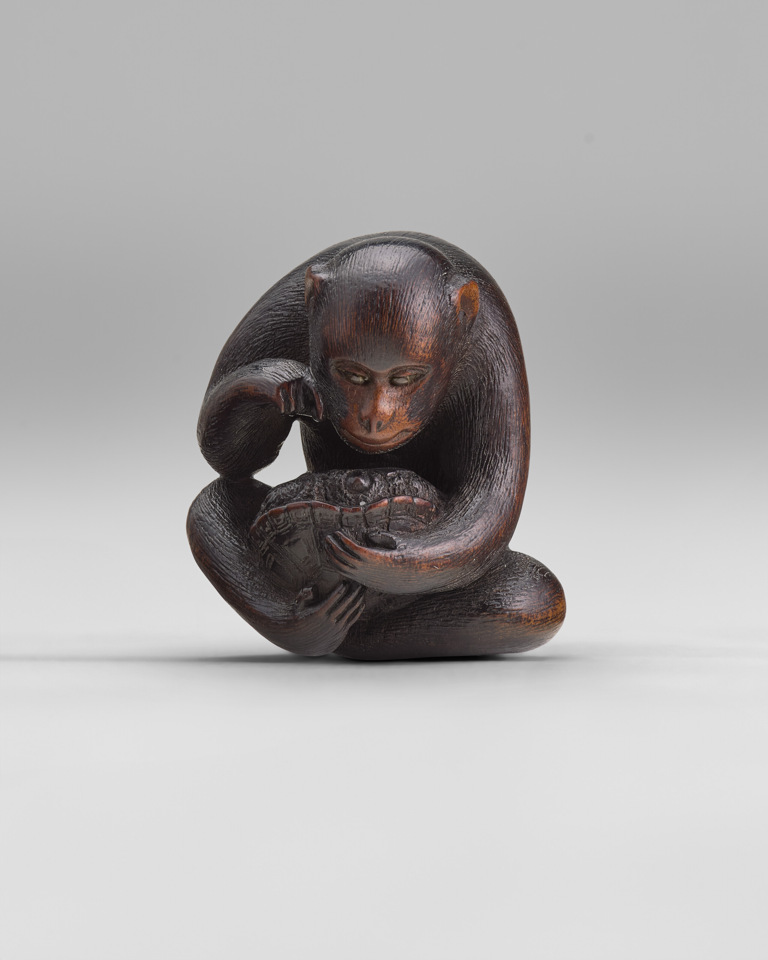 A CARVED WOOD NETSUKE OF DOGS, EDO PERIOD (19TH CENTURY), SIGNED