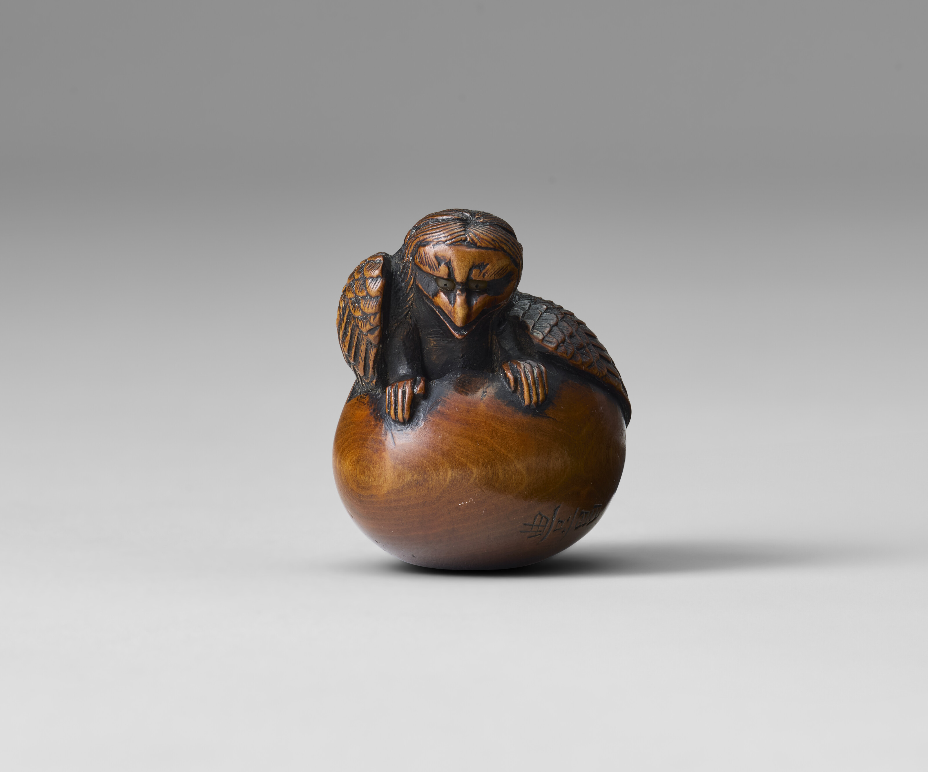 A CARVED WOOD NETSUKE OF DOGS, EDO PERIOD (19TH CENTURY), SIGNED