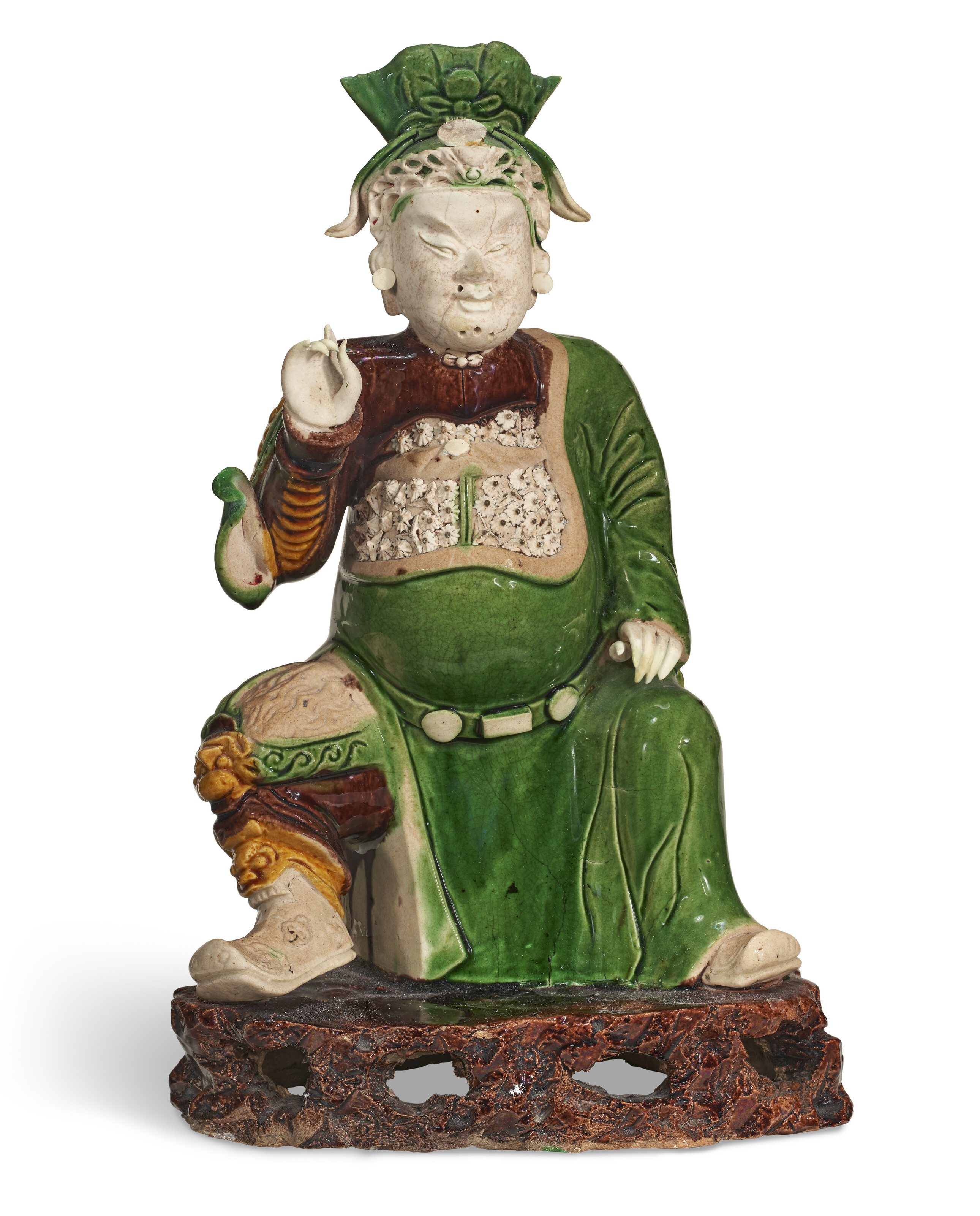 A GREEN, YELLOW AND AUBERGINE-GLAZED BISCUIT FIGURE OF A GUANDI, KANGXI ...