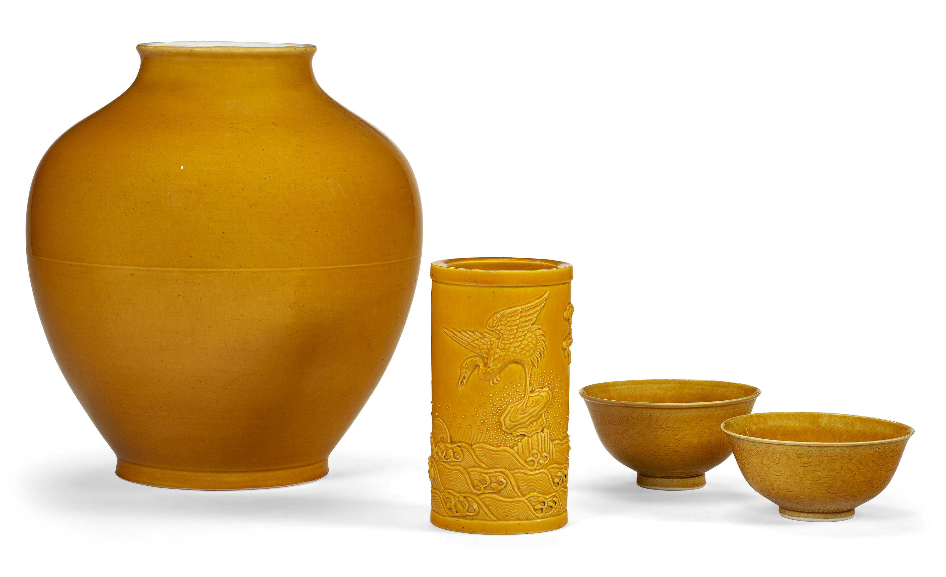 Catalog image of A GROUP OF FOUR YELLOW-GLAZED VESSELS