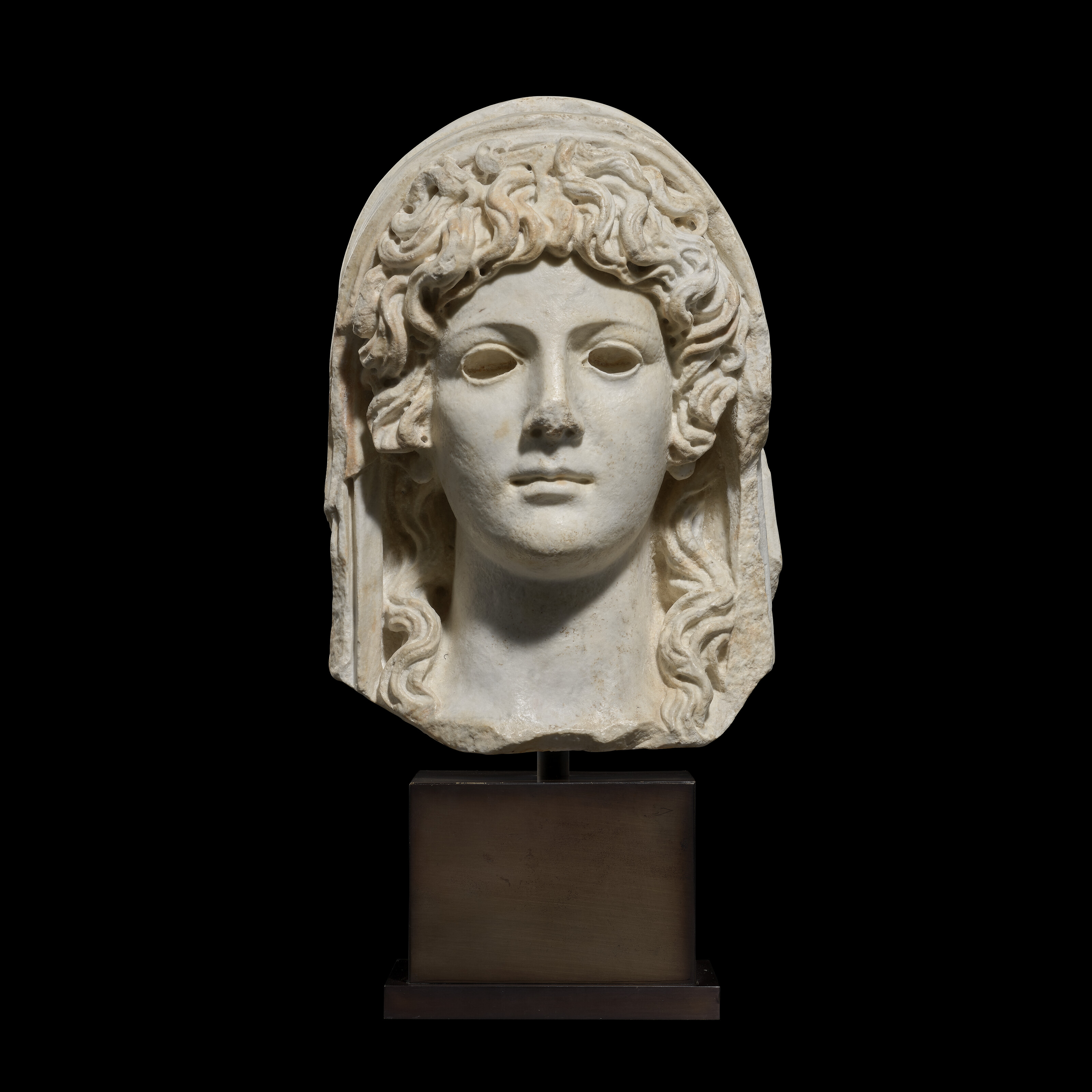A Roman marble head of a deity, circa 1st-2nd century A.D., offered in Antiquities on 3 December 2025 at Christie's in London